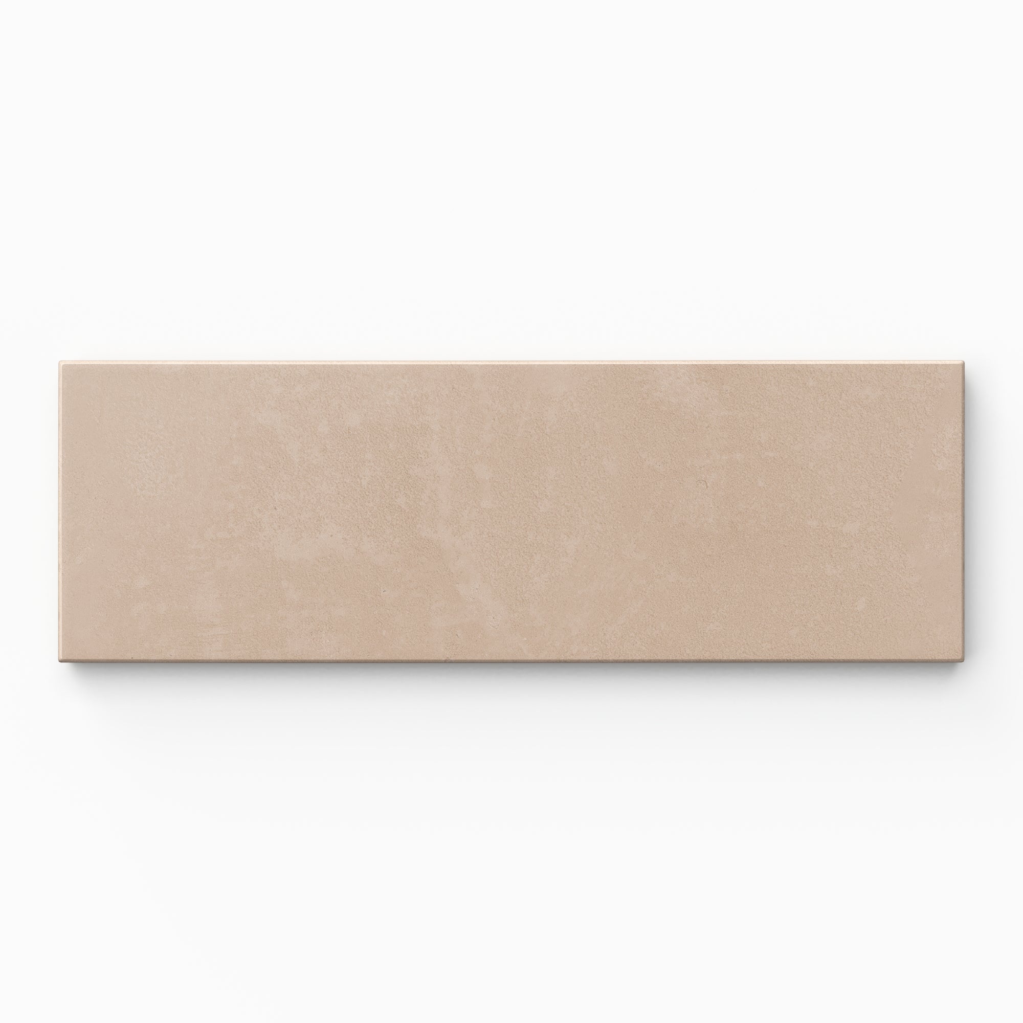 Isabel 2x6 Matte Porcelain Tile in Rosewood shows warm beige tones with faint pink warmth, finished in a powdery matte surface with lightly textured cement-plaster character.