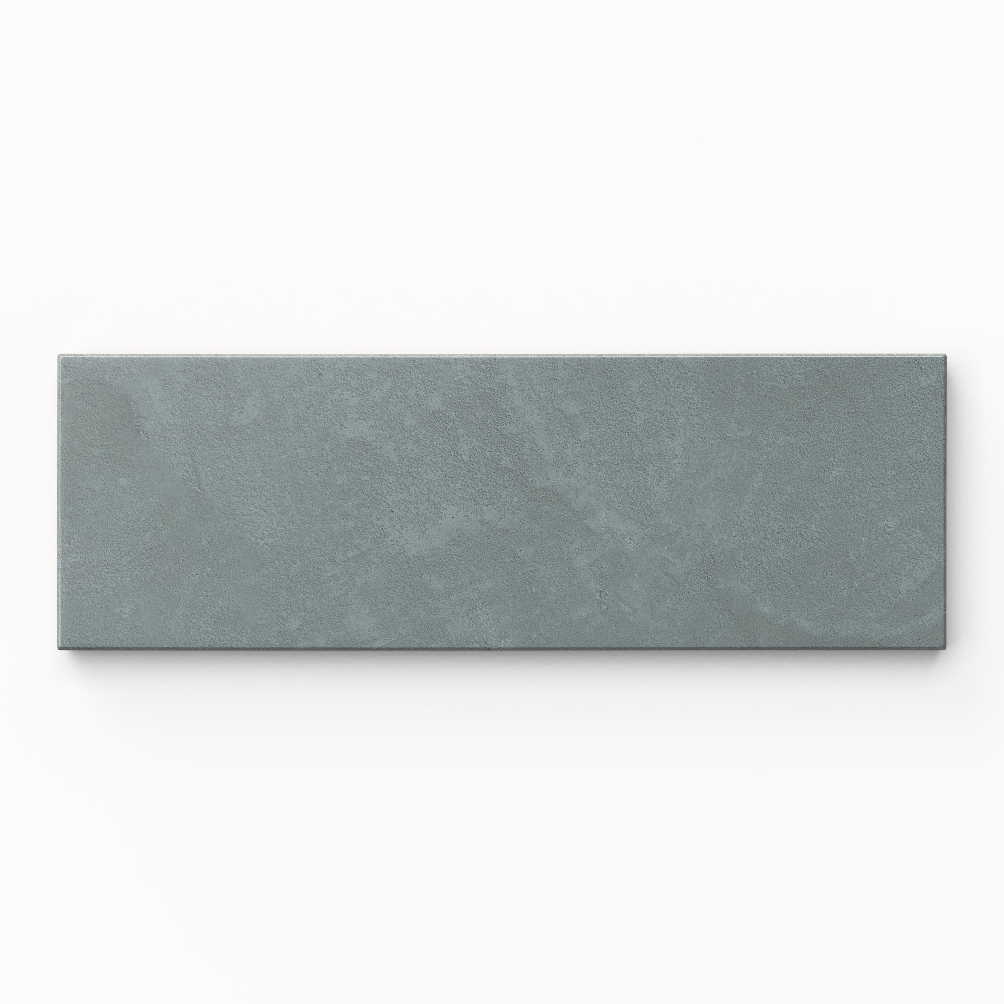 Isabel 2x6 Matte Porcelain Tile in Slate highlights a modern subway shape with layered blue tones, a powdery matte glaze, and lightly textured cement-plaster detailing.