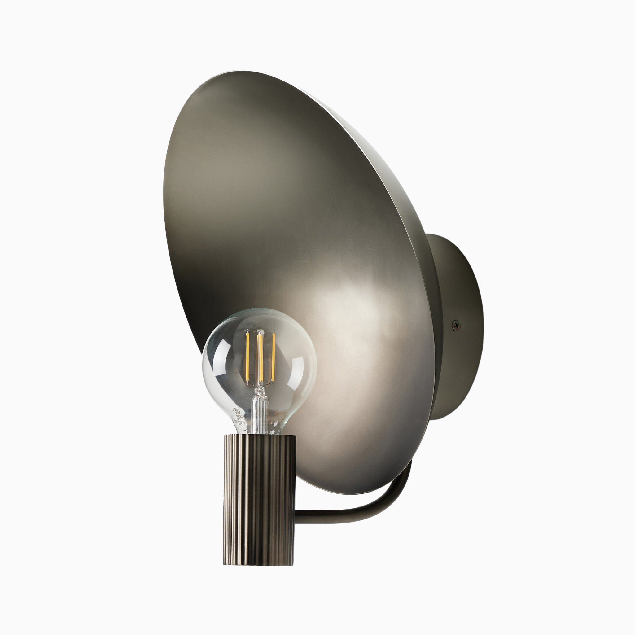 Contemporary wall sconce in aged nickel with a ribbed cylindrical socket, exposed bulb, and wide dish-shaped reflector.