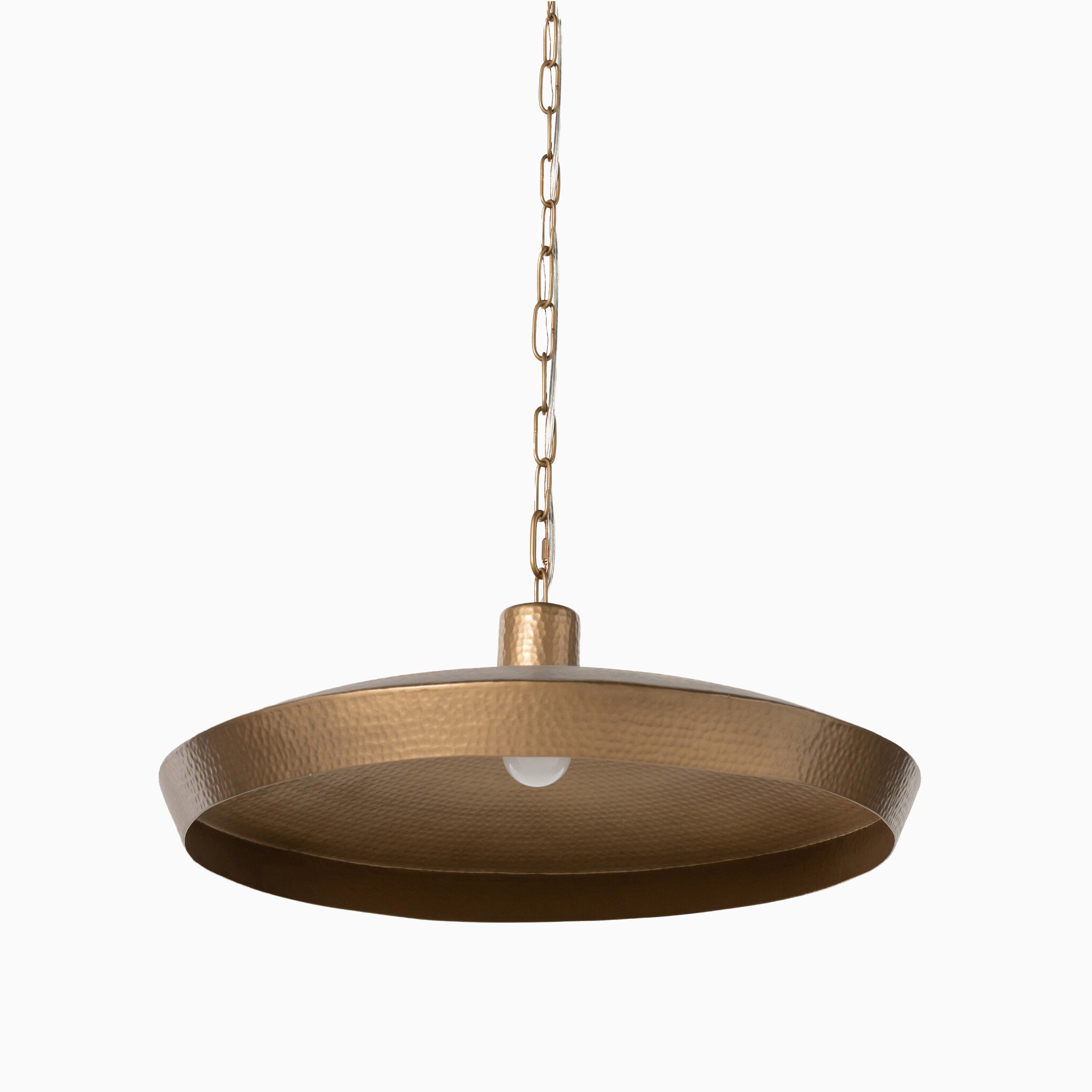 Pendant light with a wide, shallow hammered antique brass shade, suspended by a matching chain and housing a central exposed bulb.