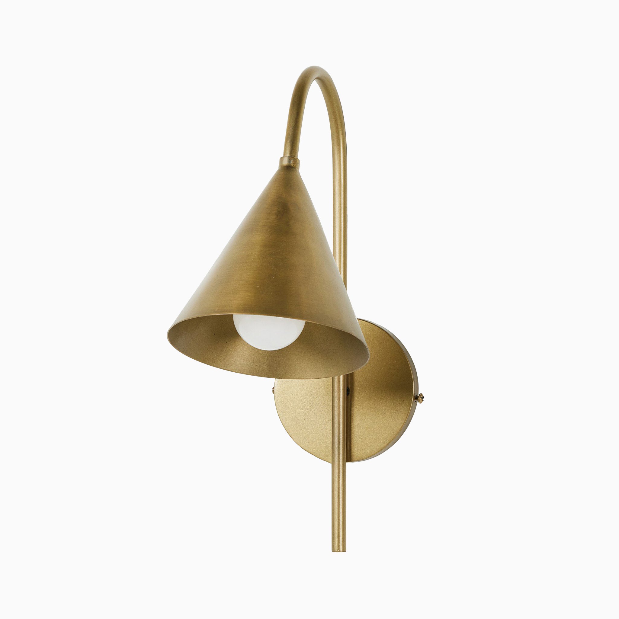 Wall sconce in light antique brass with a conical shade, curved arm, and round backplate, featuring a downward-facing bulb.