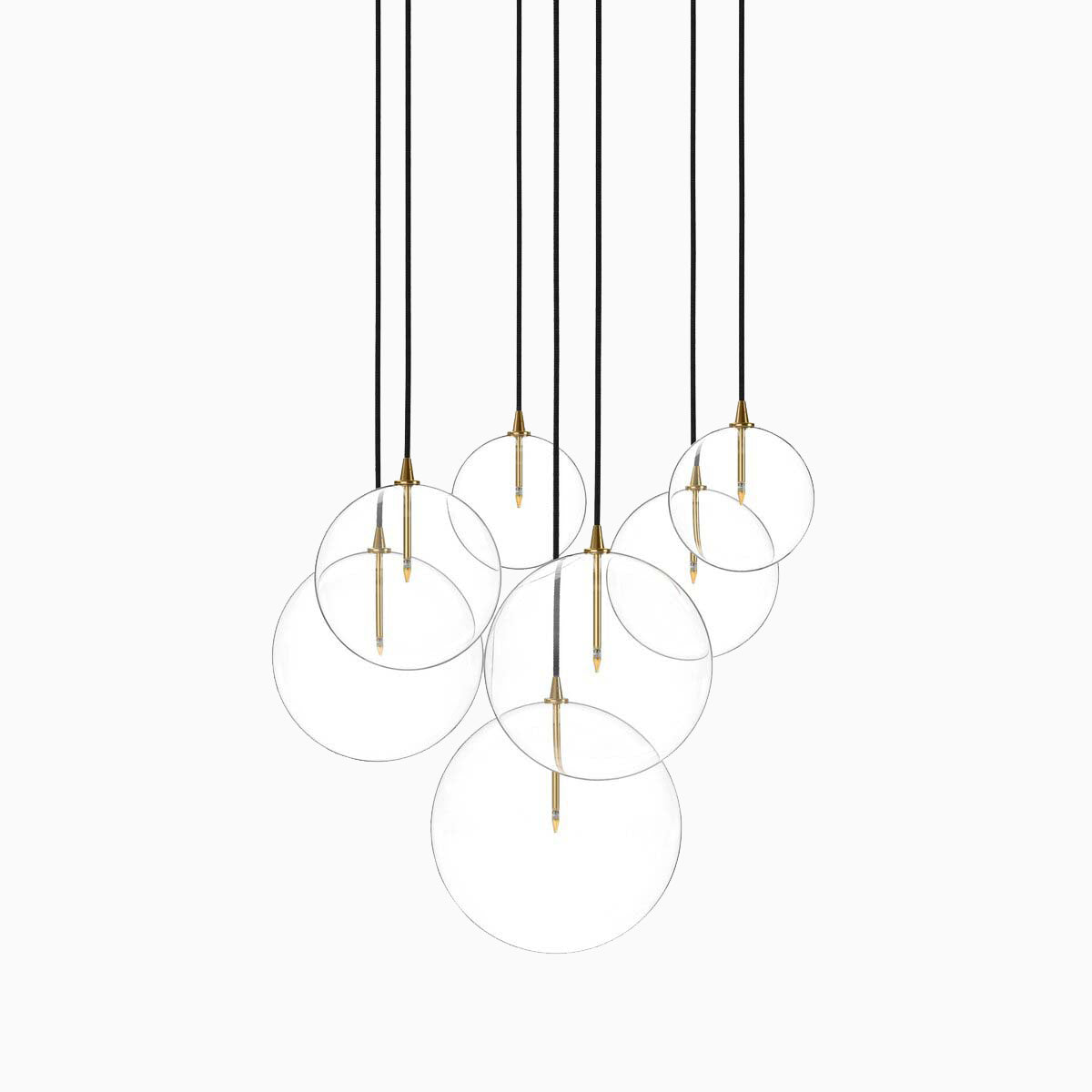 Chic burnished brass chandelier with suspended clear glass globes and slender gold stems for a luxe floating effect.