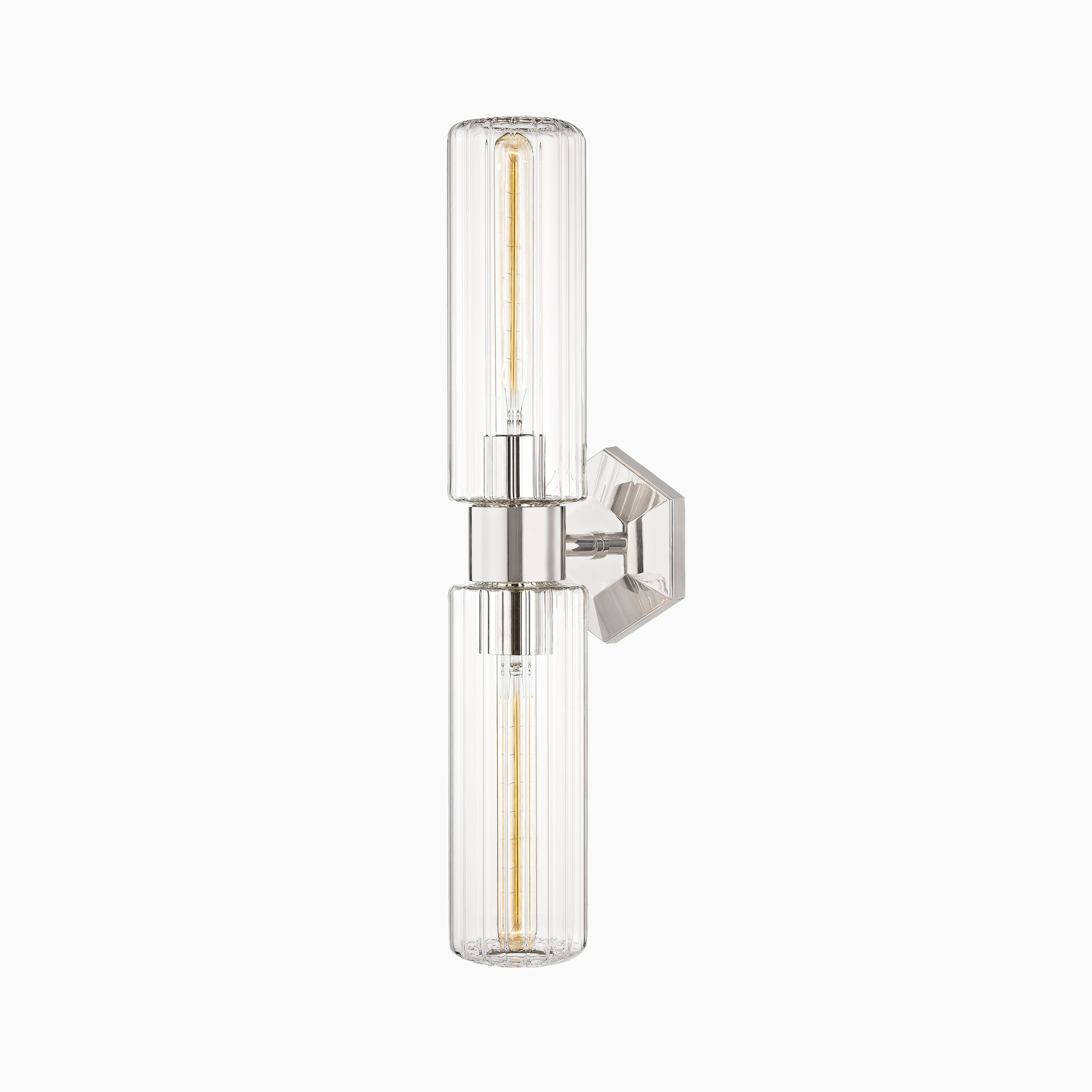 Wall sconce with polished nickel finish, hexagonal backplate, and twin cylindrical fluted glass shades for radiant, ambient glow.