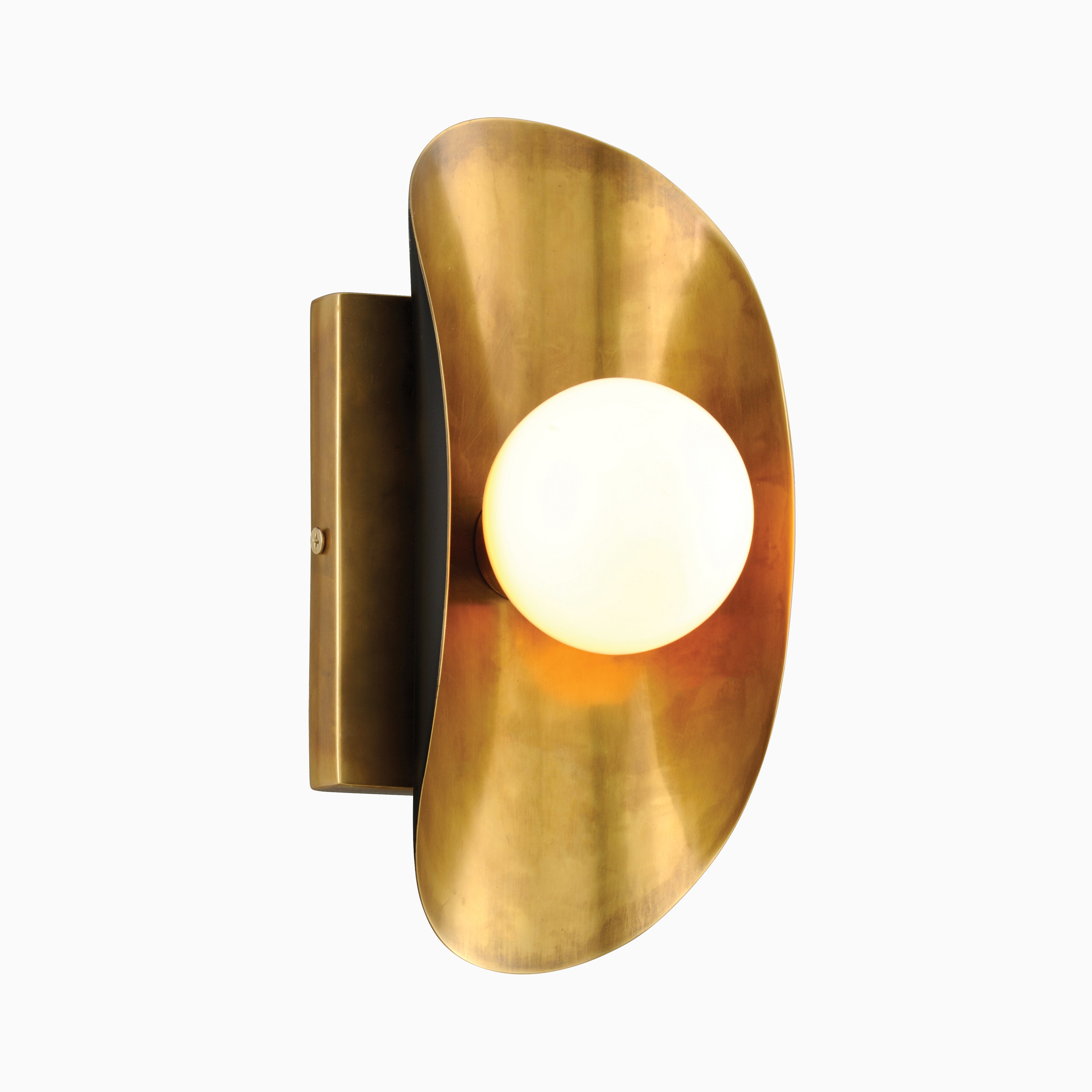 Wall sconce with a curved brass elliptical plate, frosted glass globe, and dark bronze backing for a warm, sculptural glow.