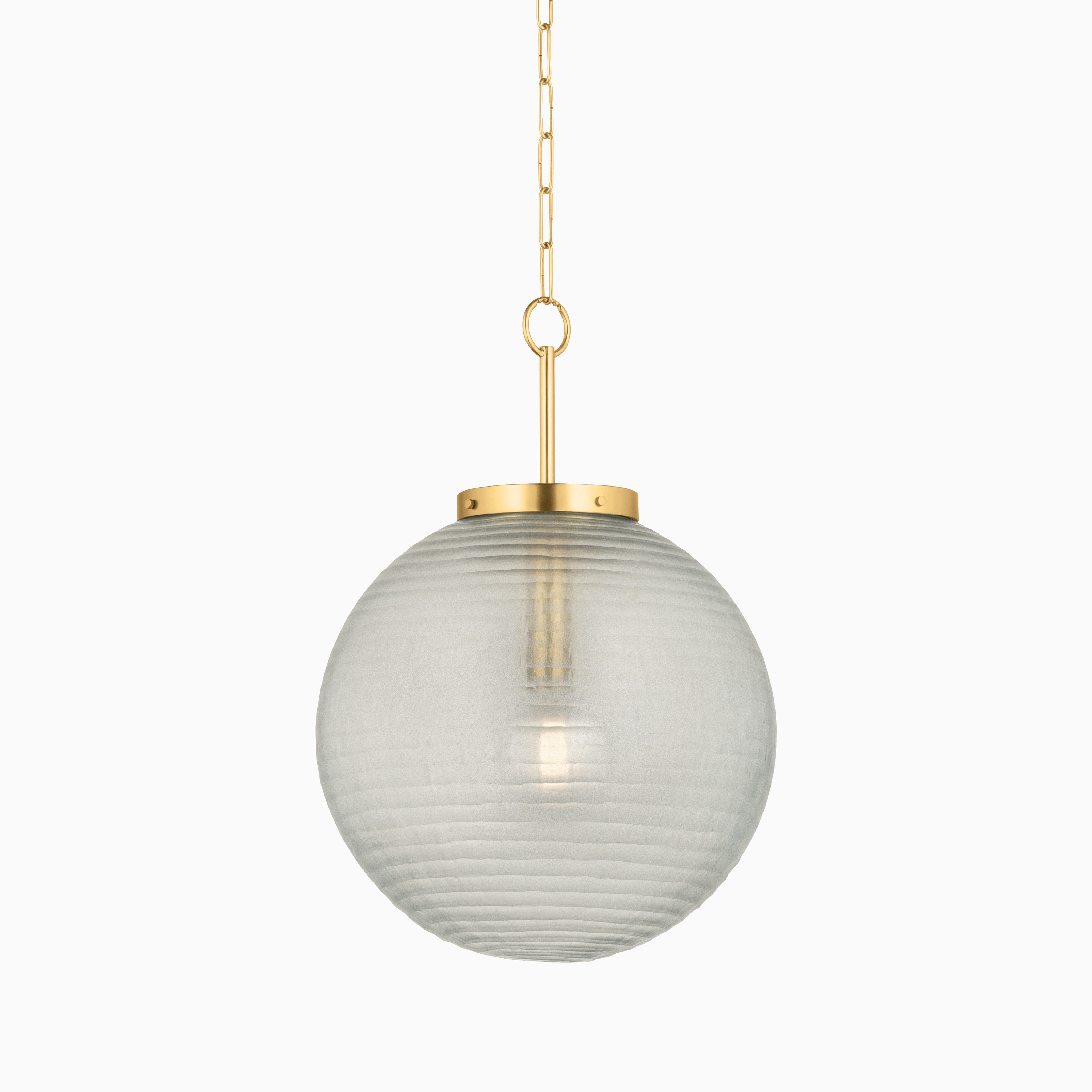 Round glass pendant light with subtle horizontal texture, suspended by an aged brass rod and chain from a matching ceiling mount.