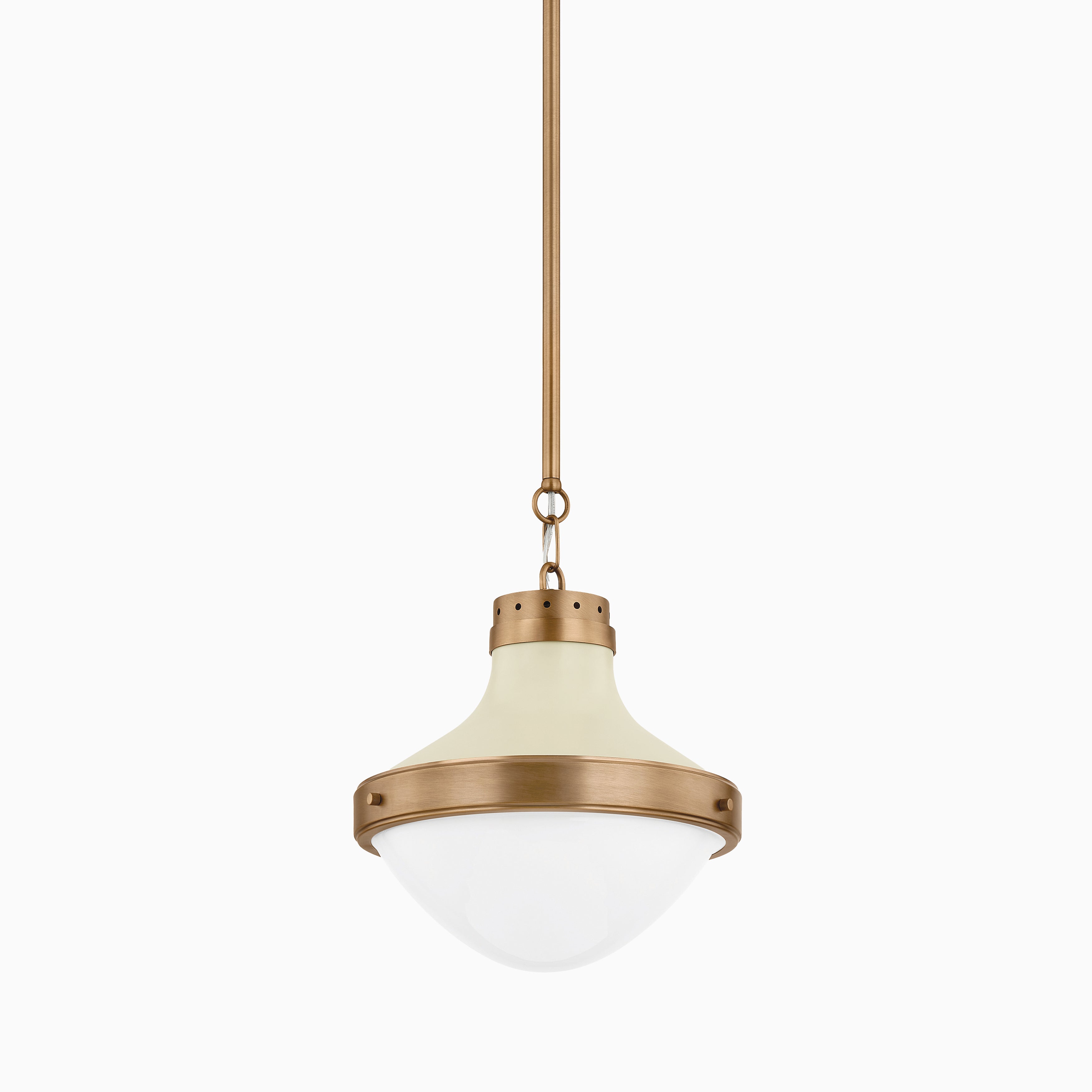 Pendant light with patina brass and soft sand finish, contoured metal canopy, semi-opaque glass shade, and vented crown for warm ambient glow.