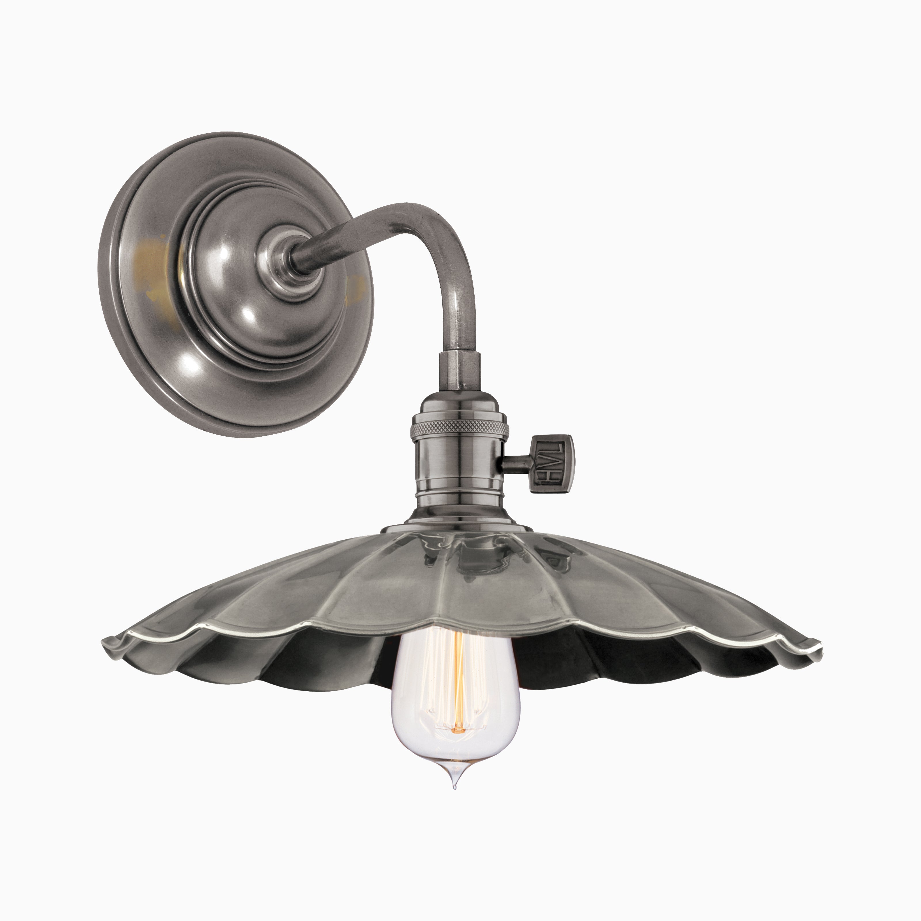 Industrial-style wall sconce in gunmetal finish with a scalloped shade and exposed bulb, evoking vintage character