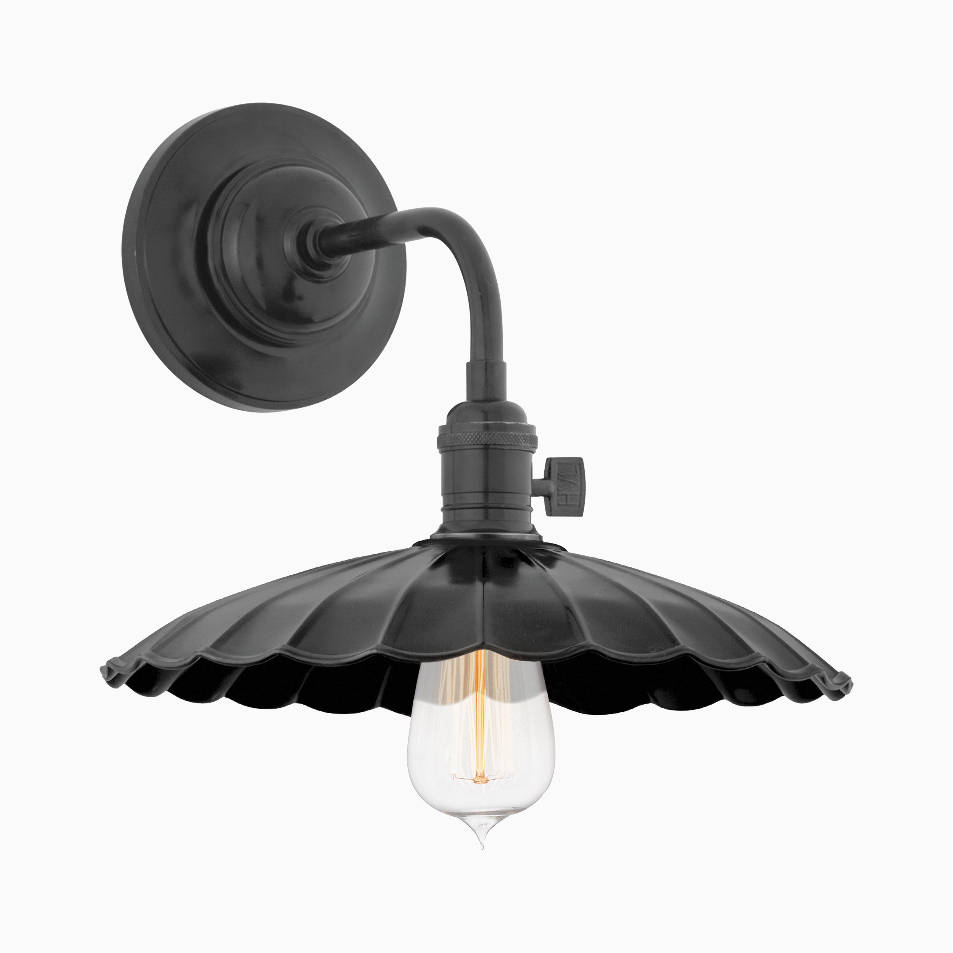 Black wall sconce with scalloped metal shade and exposed bulb, blending vintage charm with bold industrial style