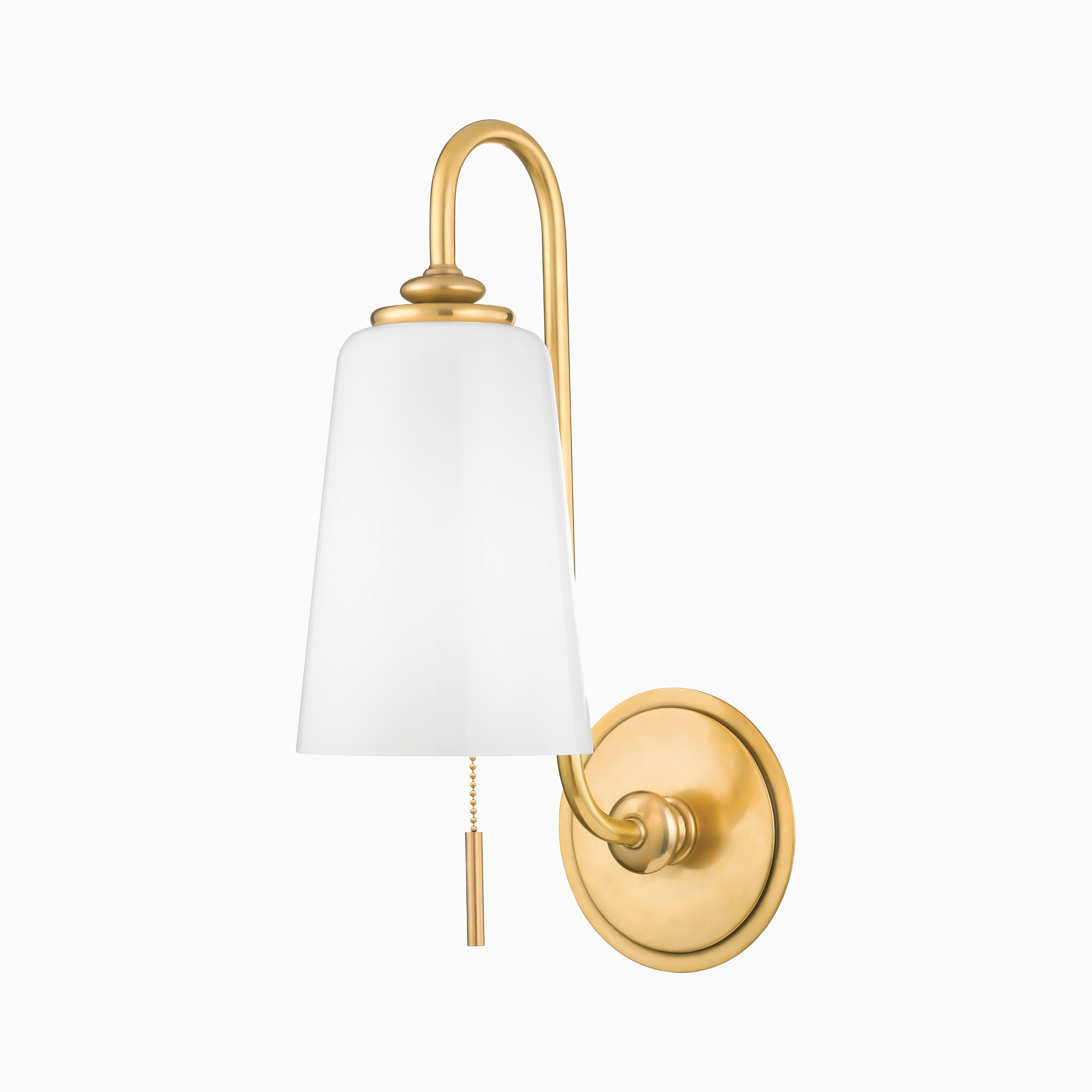 Traditional wall sconce with an aged brass finish, curved arm, white tapered glass shade, and pull chain switch for operation.