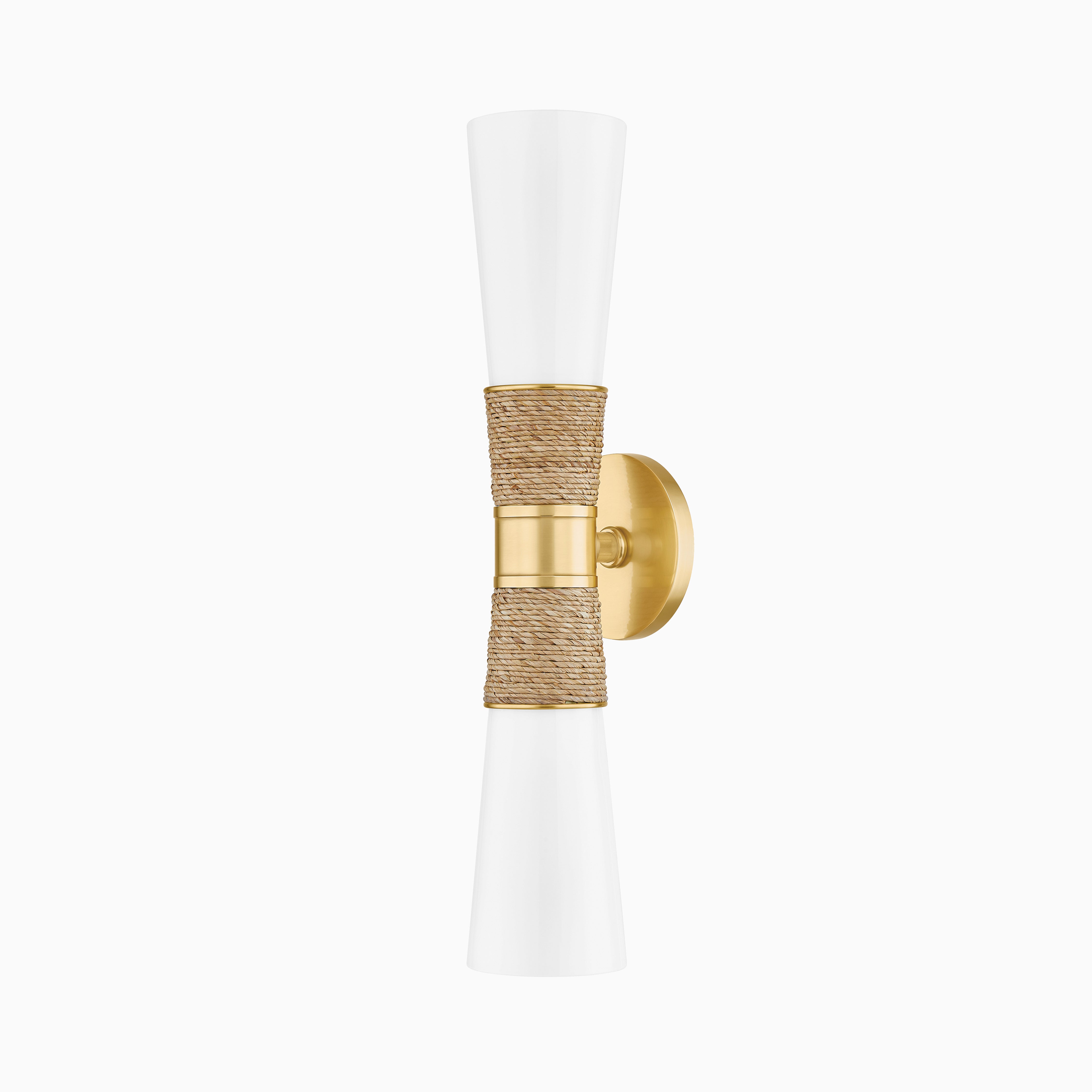 Aged brass wall sconce with flared white opal glass shades and handwoven raffia detailing for a coastal-modern look.