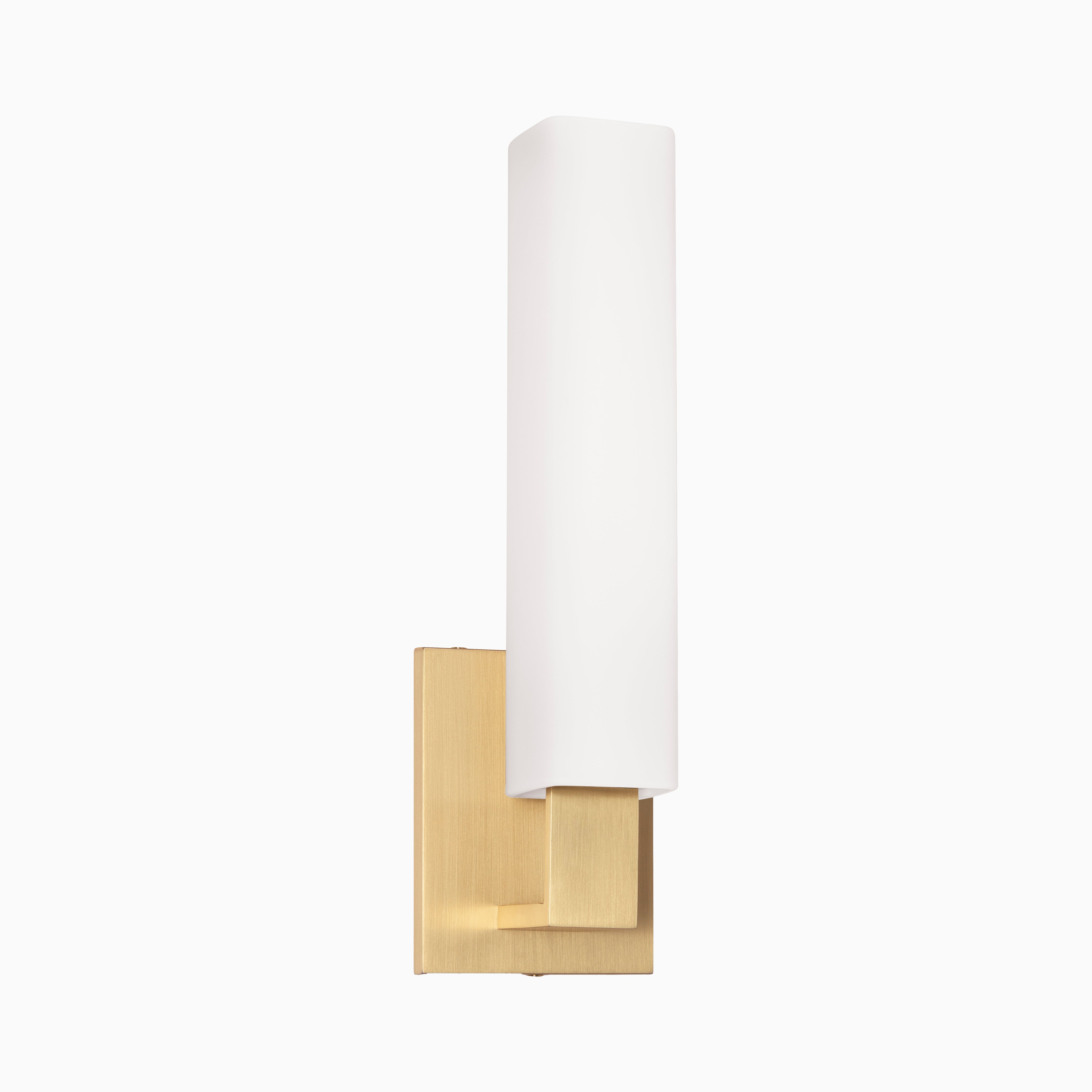 Vertical wall sconce with a tall opal glass diffuser and aged brass backplate, blending minimalist lines with warm, structured elegance.