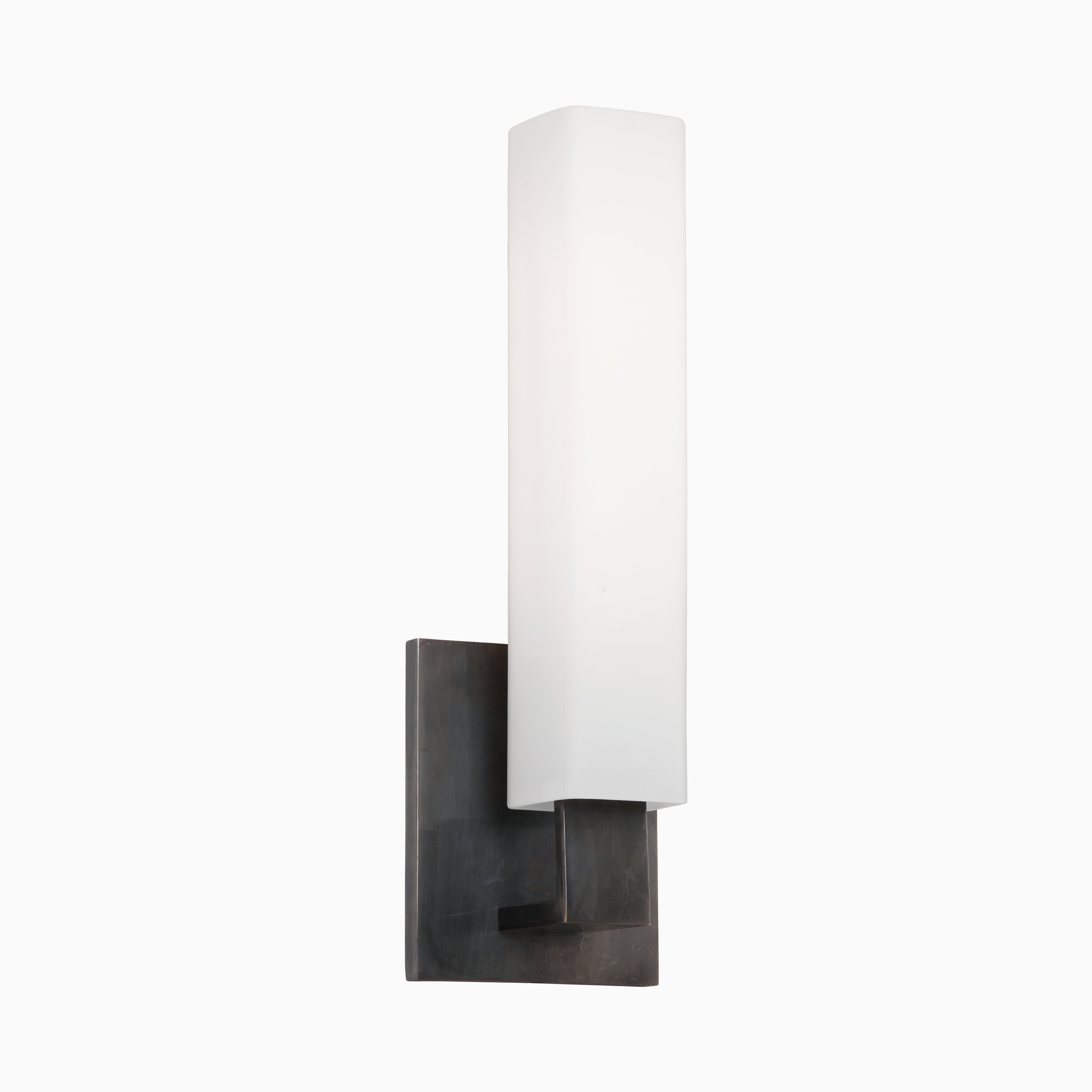 Vertical wall sconce with tall opal glass diffuser and minimalist old bronze backplate, offering bold contrast and modern structure.