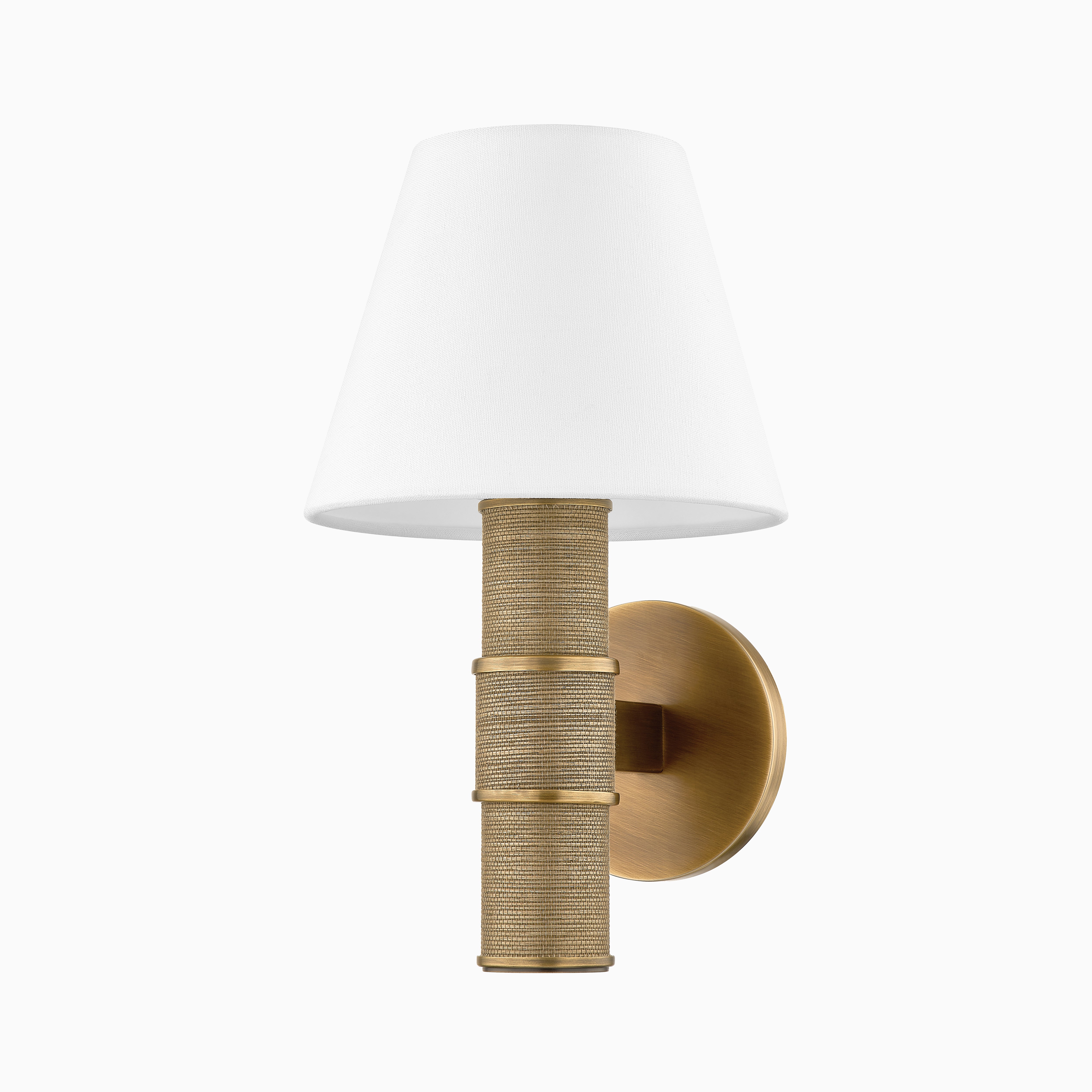 Patina brass wall sconce with woven grass cloth wrapped base and white tapered fabric shade, blending texture with modern design.