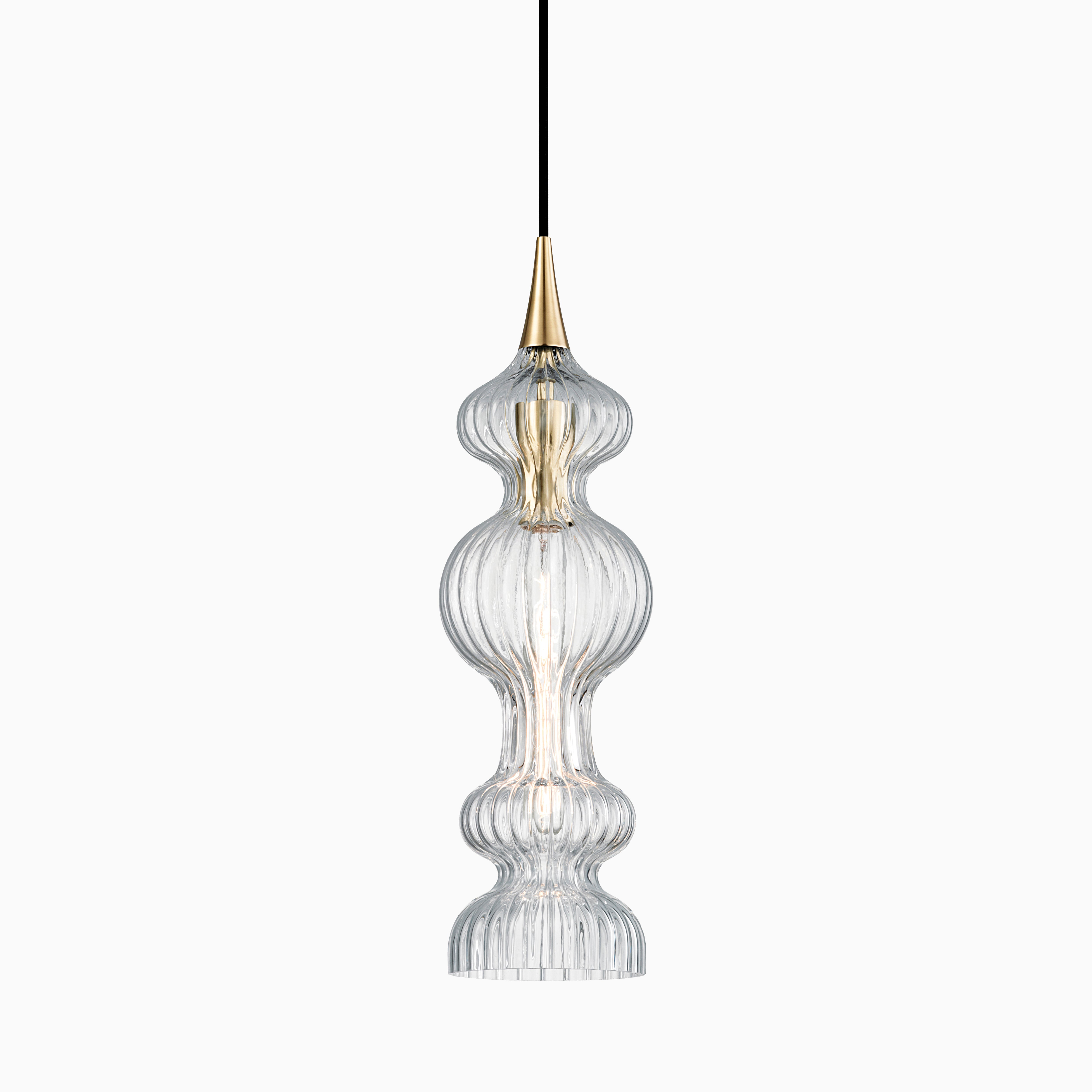 Elongated pendant with tiered, ribbed glass and aged brass accents, casting shimmering light through sculptural curves.