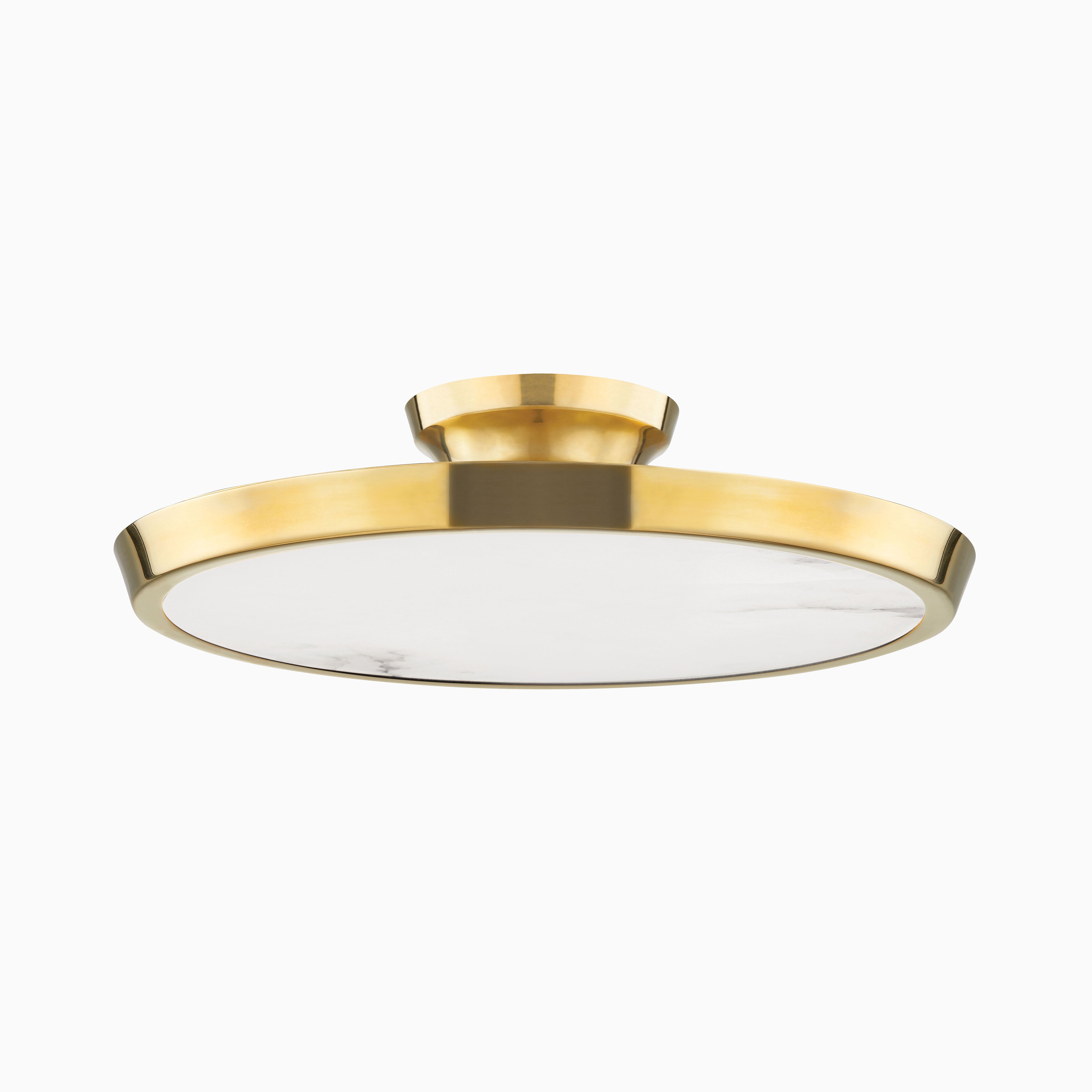 Modern flush mount light in aged brass finish with a wide flat circular shade and low-profile design for refined contemporary spaces.