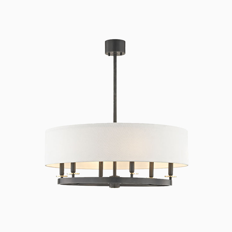 Chandelier with an off-white linen drum shade and black aged old bronze ring base, casting soft ambient light with bold contrast.