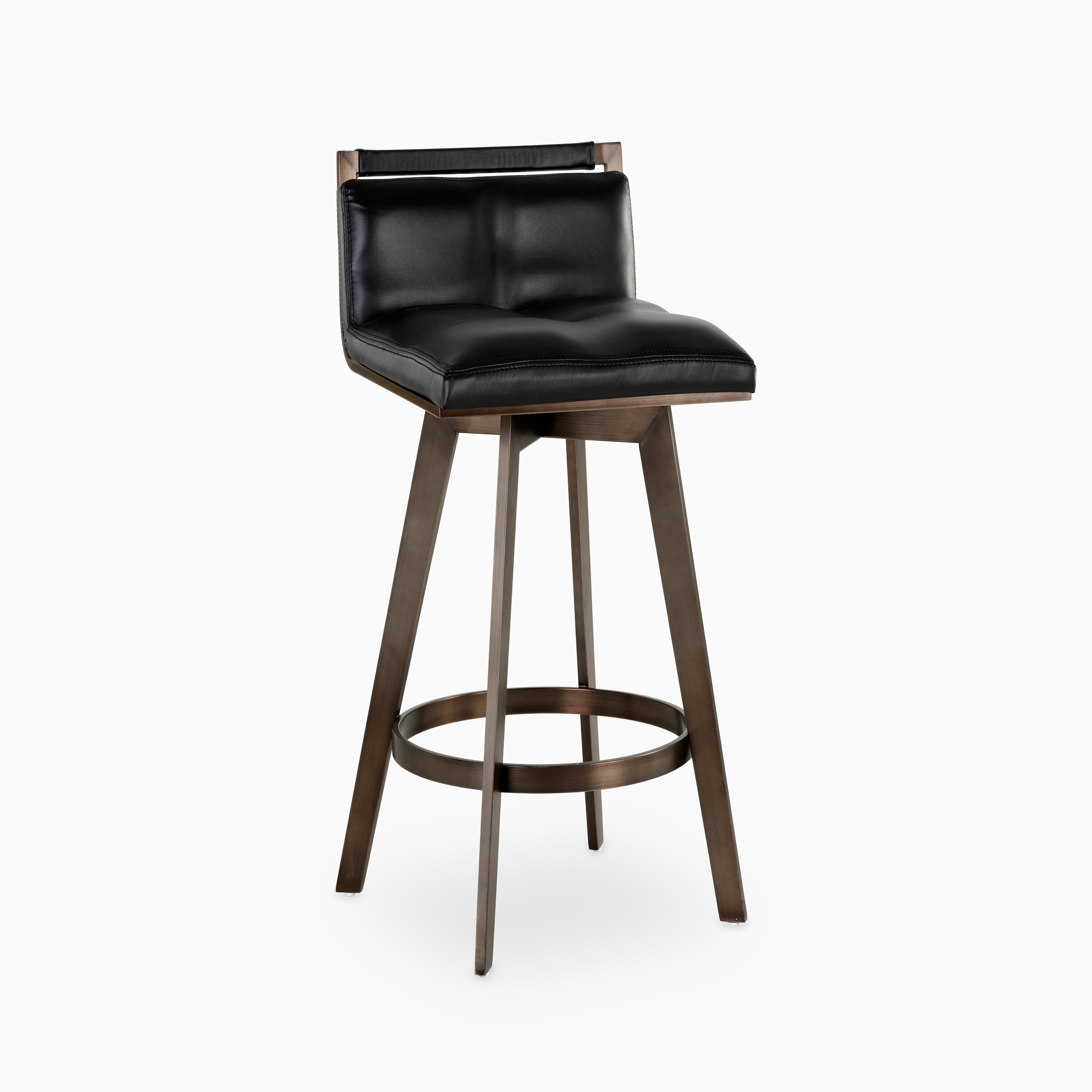 Swivel counter stool with tufted black leather seat, low backrest, and bronze angular base featuring a circular footrest.