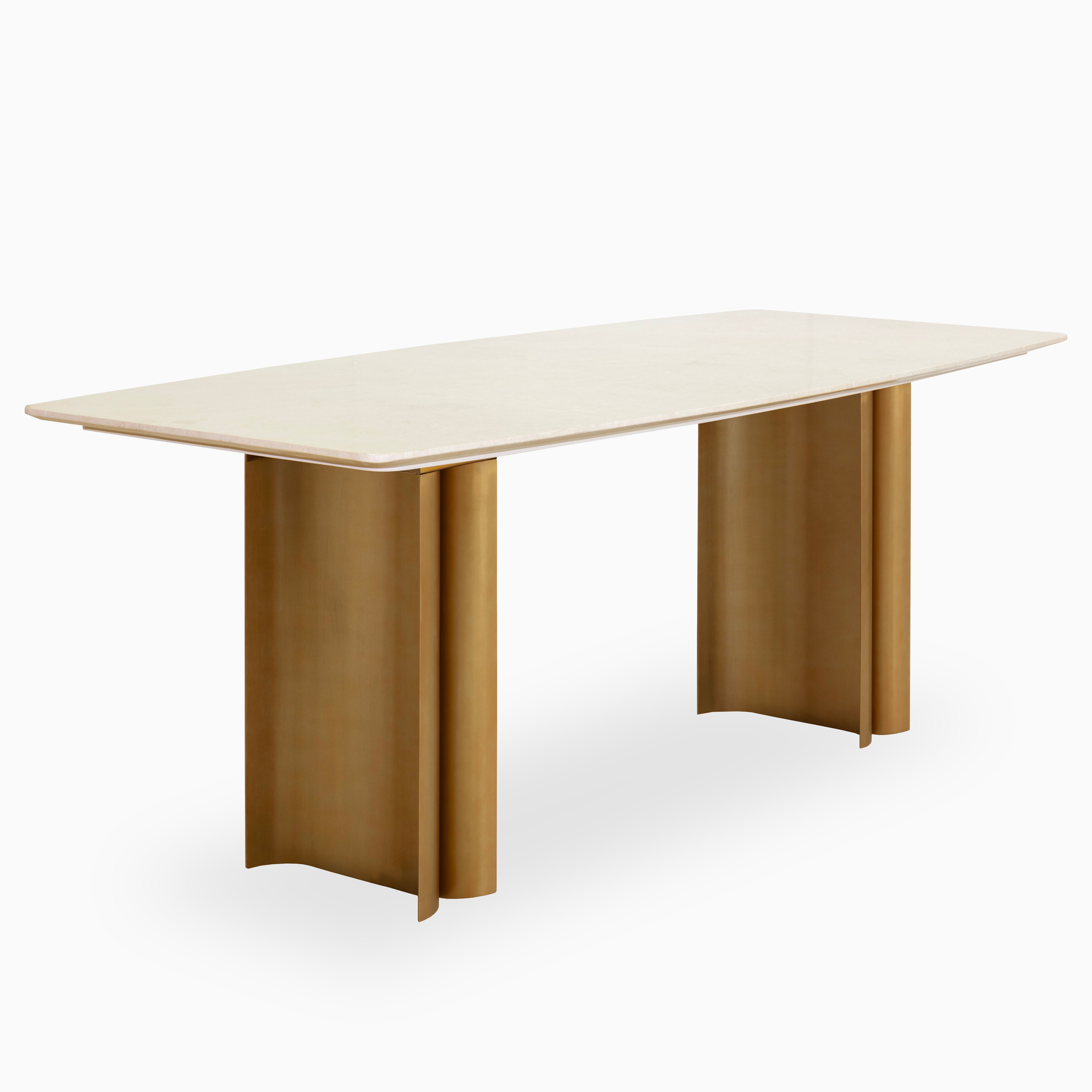 Elegant 94.5-inch dining table with a smooth rectangular stone top and sculptural dual pedestal brass base, blending modern and luxe style.