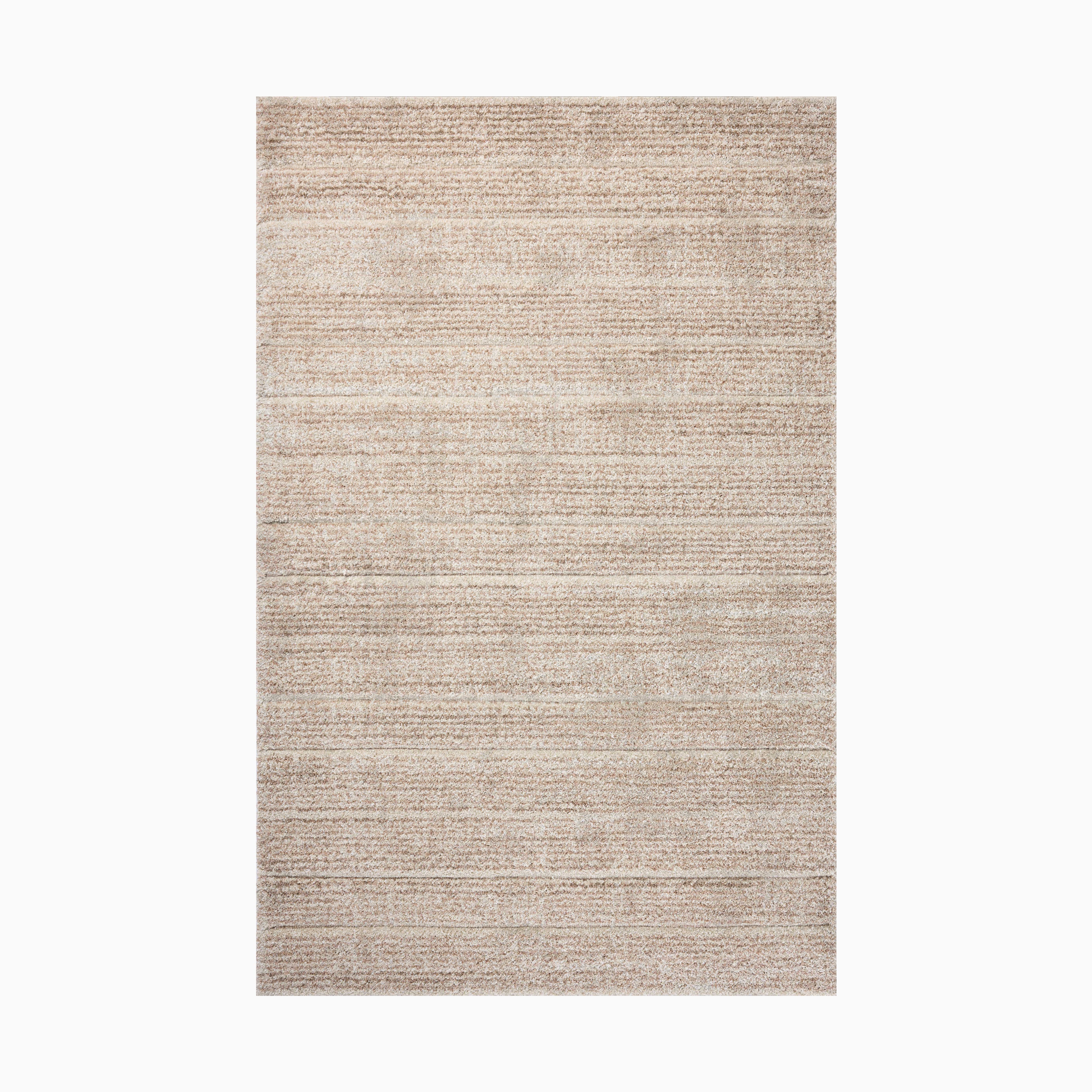 Power loomed area rug from Egypt made of polypropylene with a soft, textured linear pattern in warm beige hues, perfect for a cozy and modern space.
