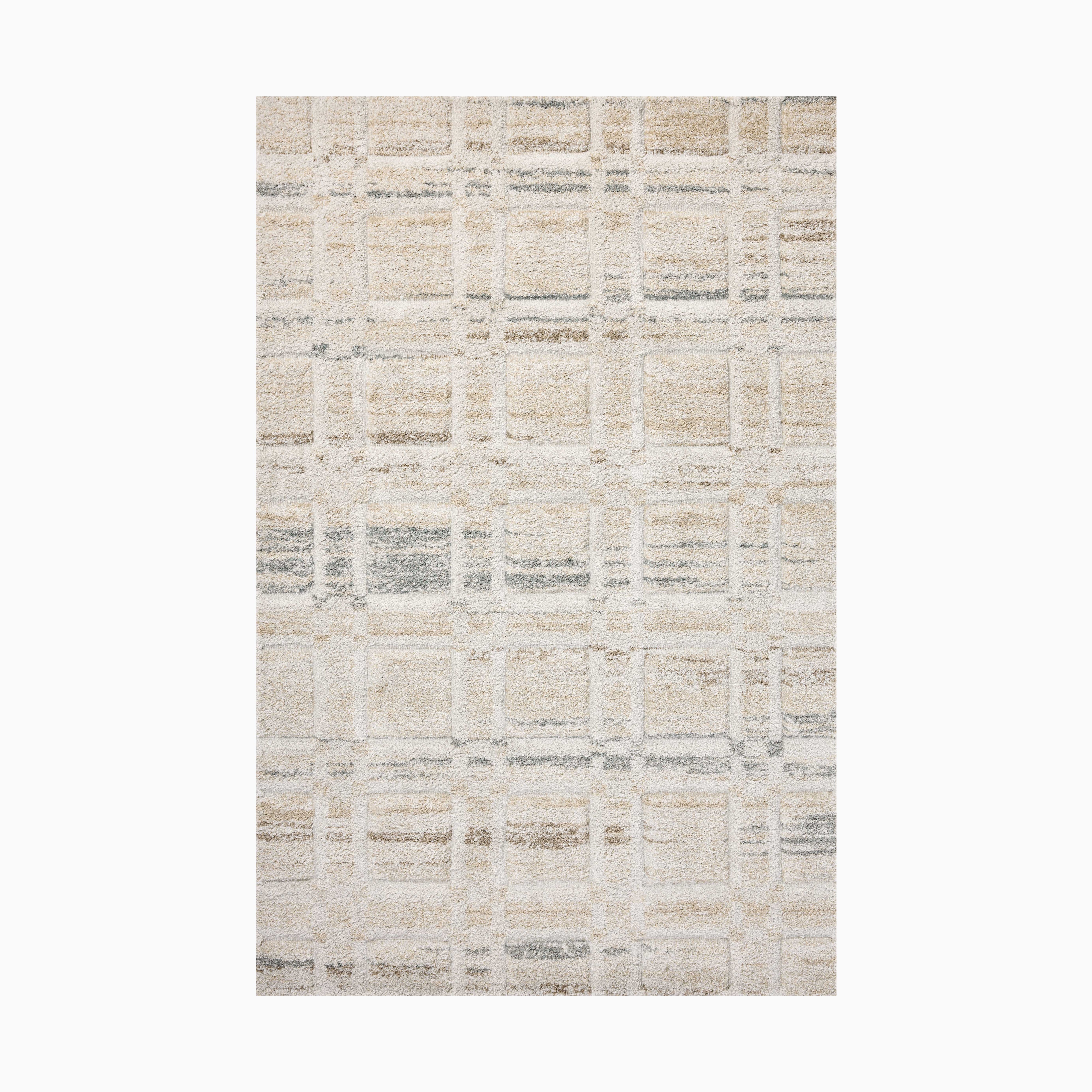 Power loomed area rug from Egypt made of polypropylene with a textured grid pattern in soft beige, ivory, and gray tones.