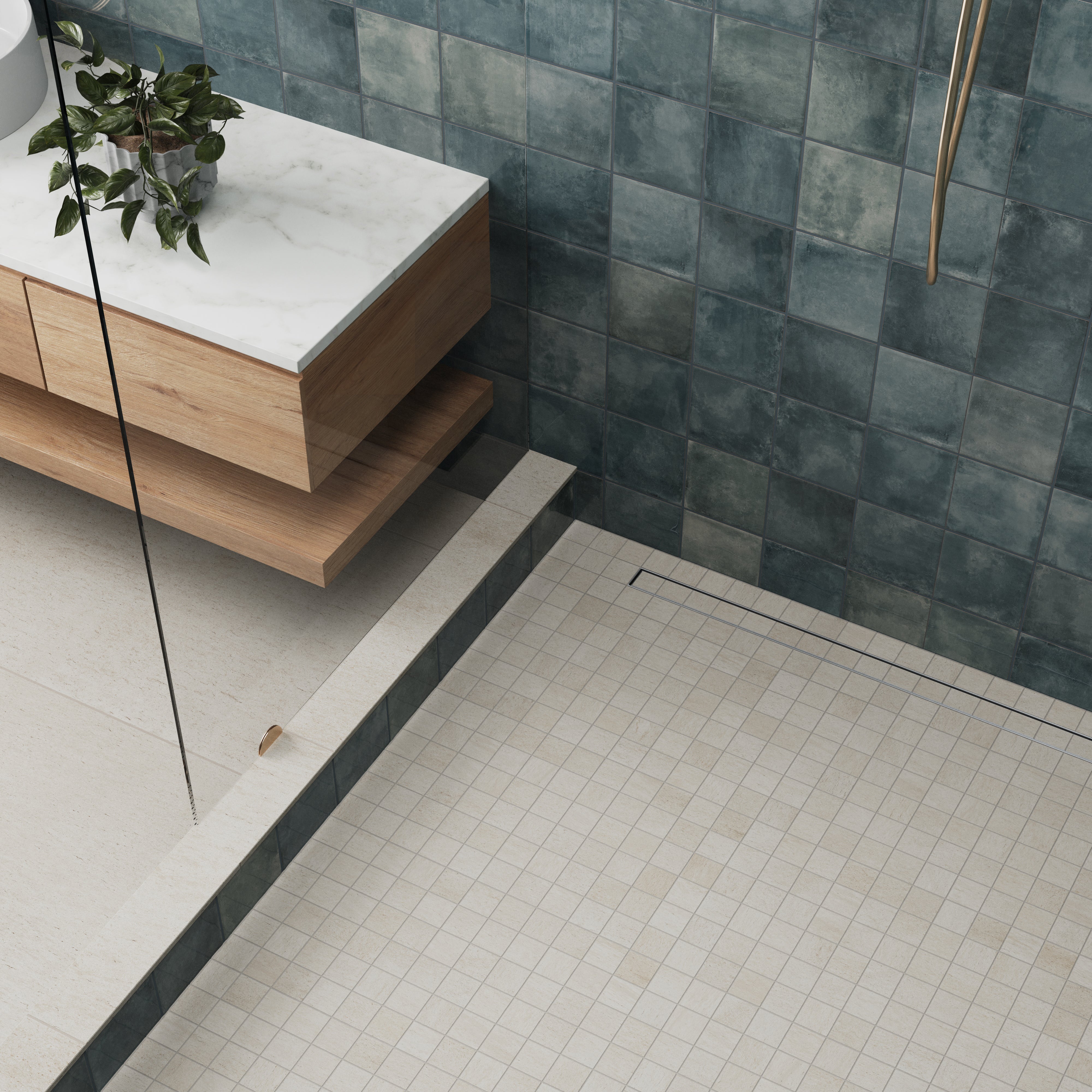 Shower floor featuring neutral-toned mosaic tiles, complementing a modern wood-and-marble vanity and textured green wall tiles.