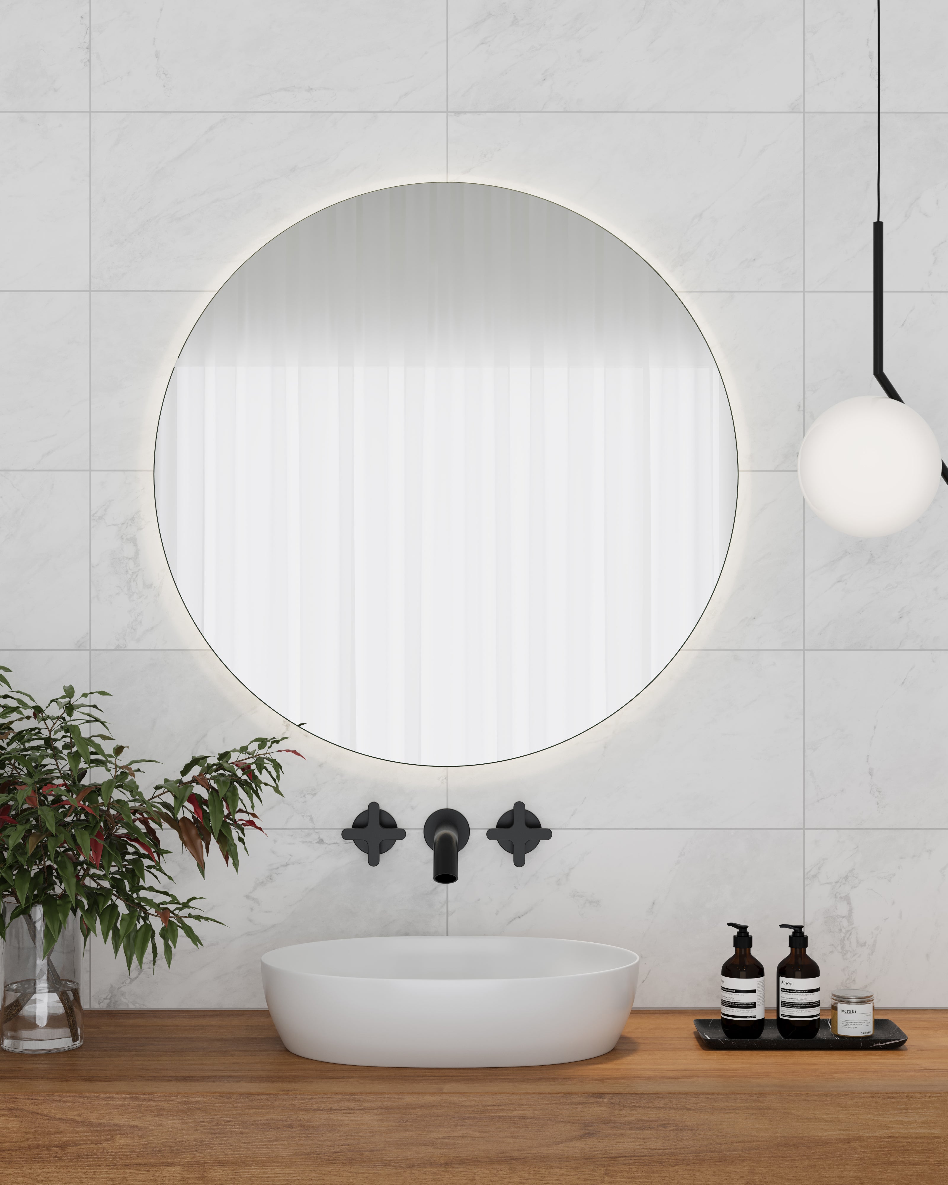 Close-up of a modern bathroom vanity with Alaska Glacier matte porcelain tiles featuring soft marble veining, a round illuminated mirror, and sleek black fixtures.