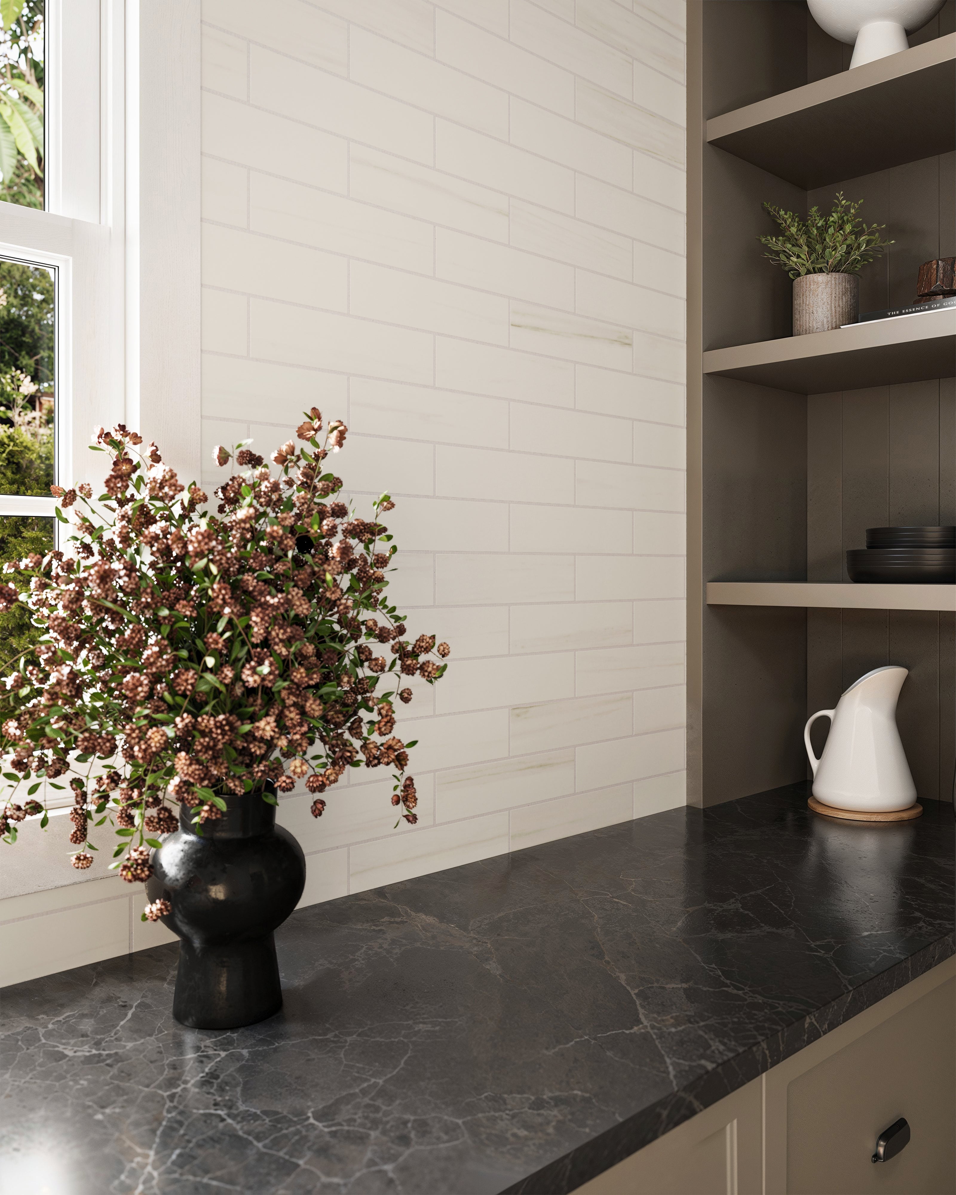 3x12 matte subway tiles in a crisp white finish line the backsplash, paired with a dark marble countertop and elegant shelving for a refined look.
