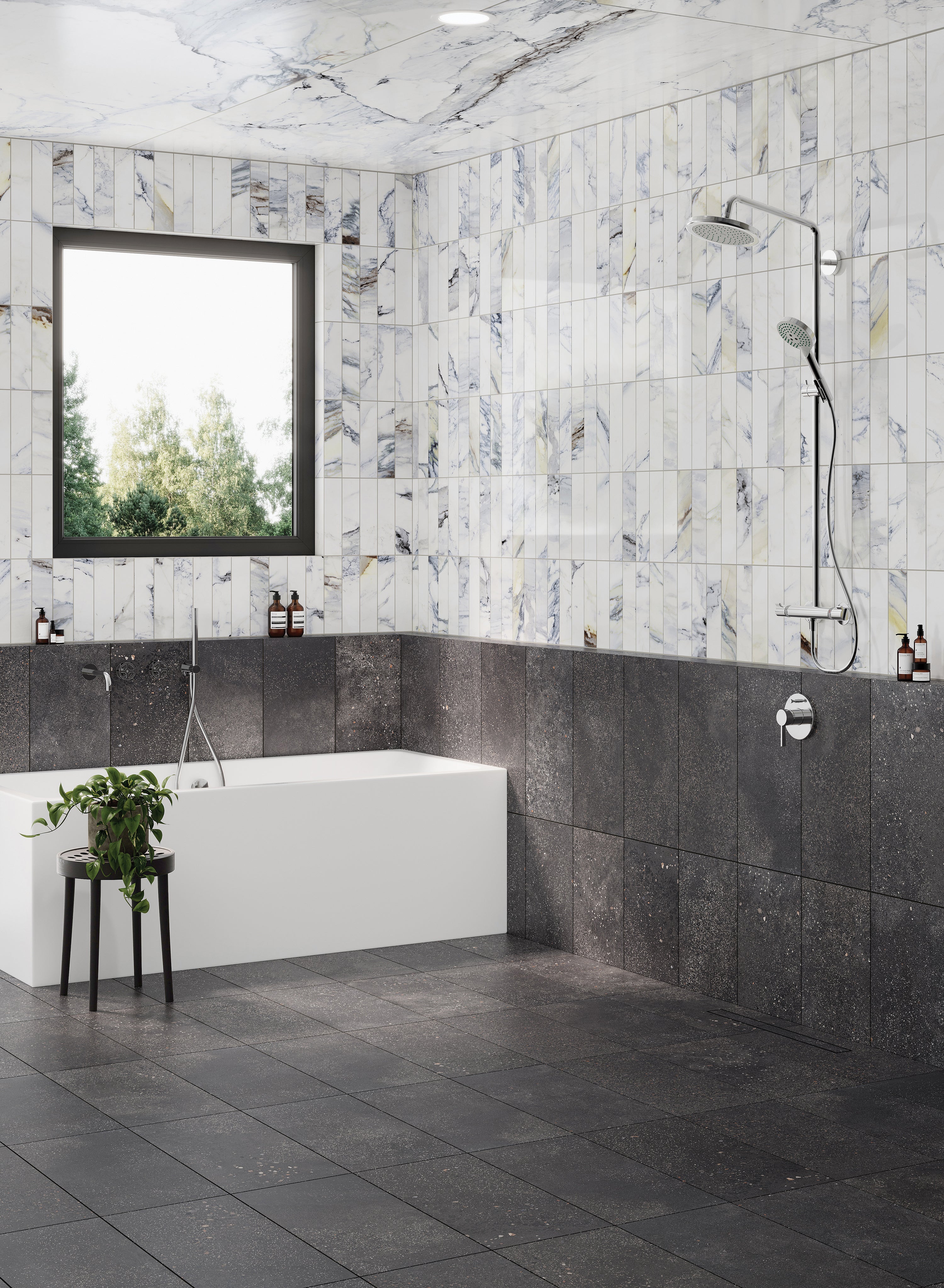 Luxurious bathroom featuring Sloane 12x24 matte porcelain tiles in Charcoal on the floor and lower walls, paired with polished marble look tiles for a stunning effect on the upper walls.