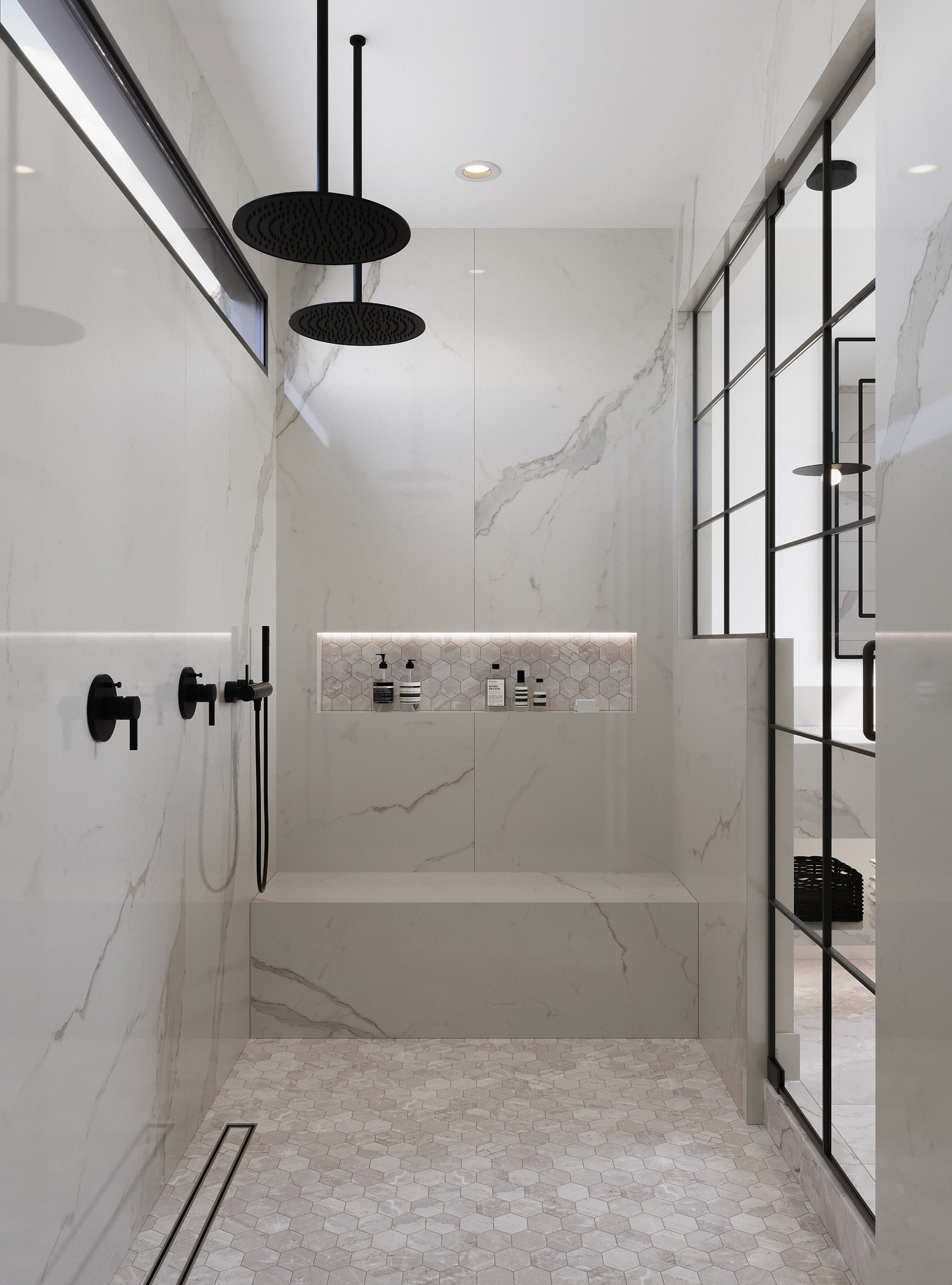 A modern shower space featuring large beige wall tiles with soft veining, complemented by matte beige hexagonal marble look mosaics on the floor and niche.