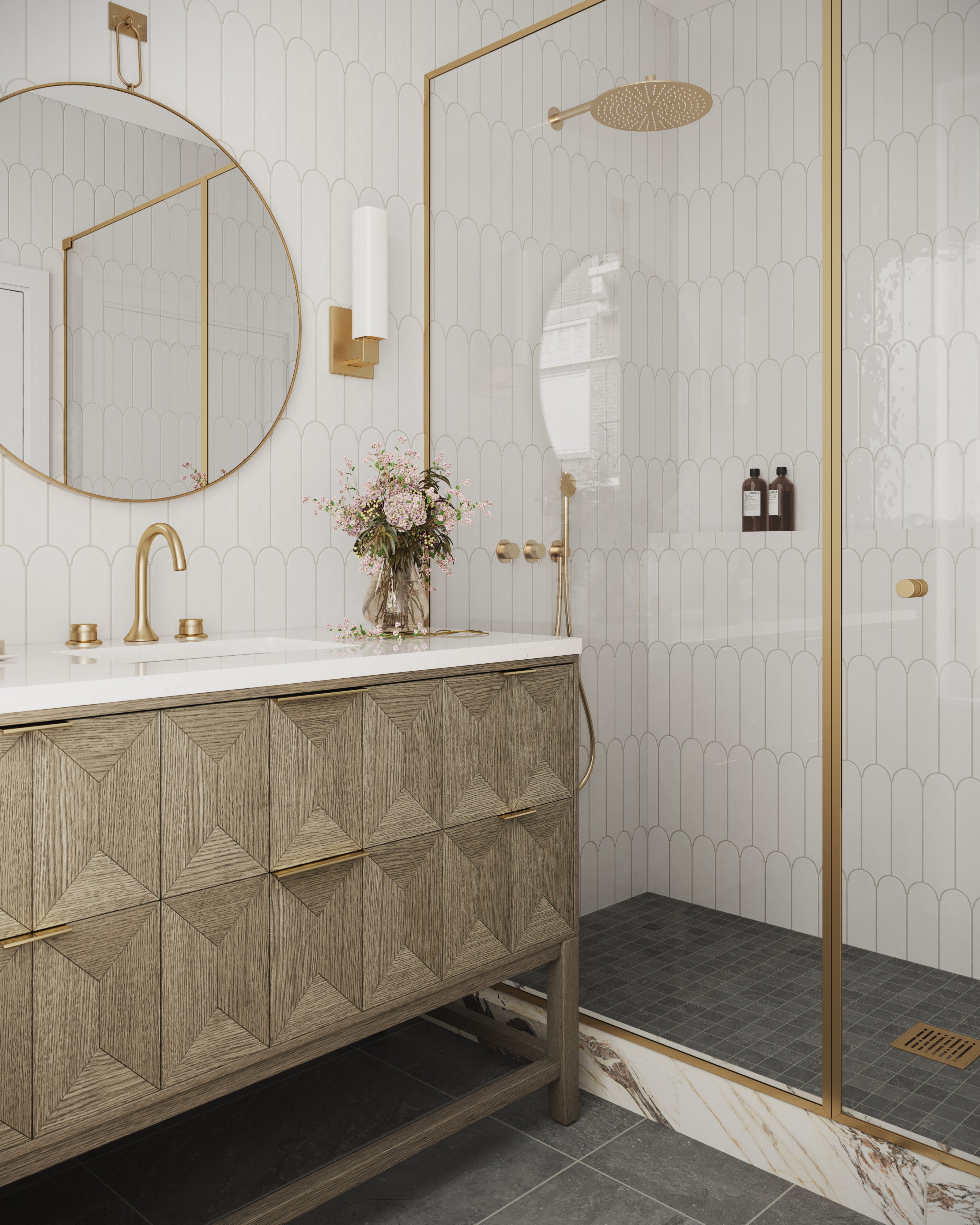 Bathroom featuring Gwen single vanity with geometric drawer fronts, set beside a gold-trimmed shower lined in cloud-white fishscale wall tiles.