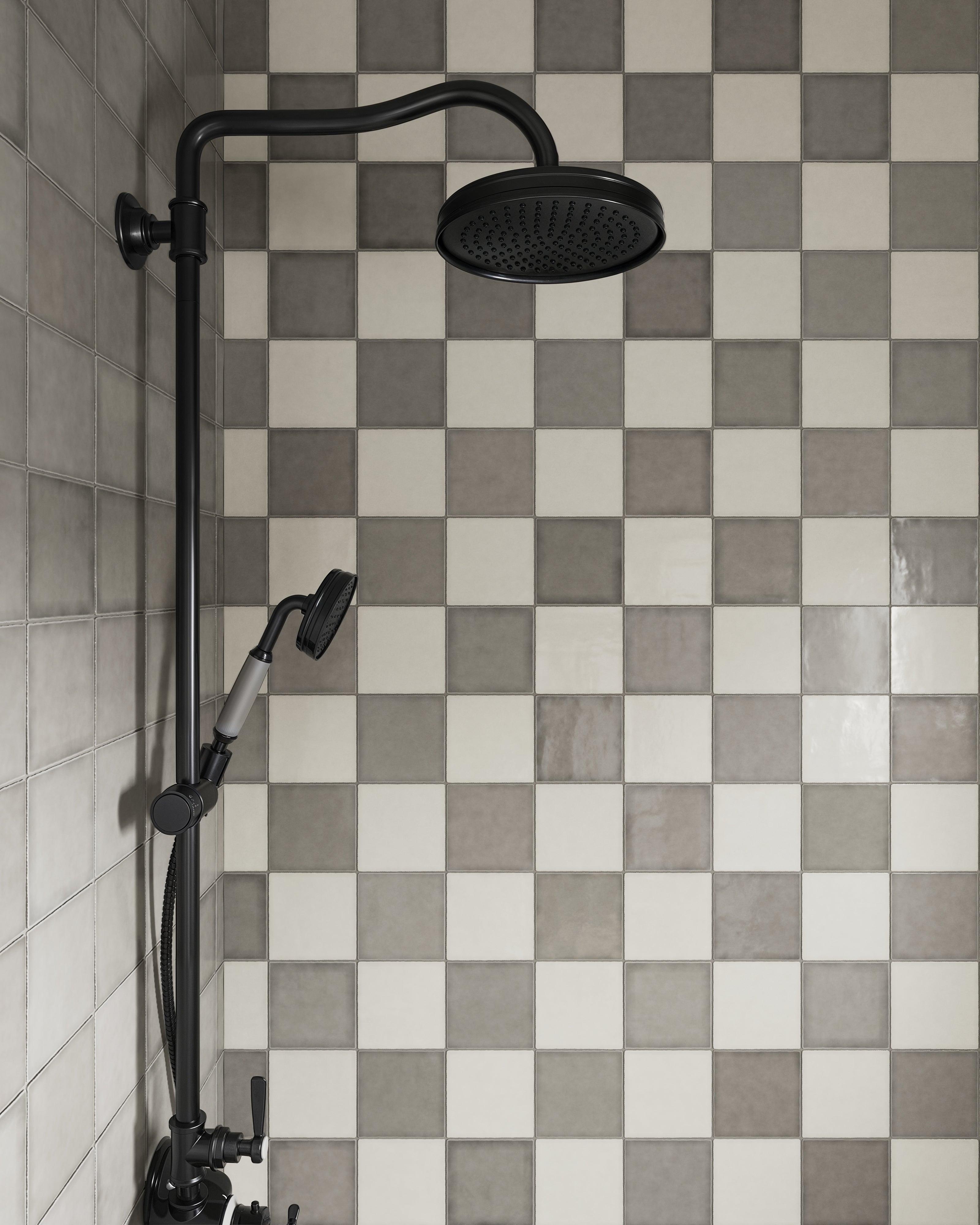 Modern shower design featuring glossy square tiles in a chic smoke gray and white checkerboard pattern, paired with a matte black rainfall shower head