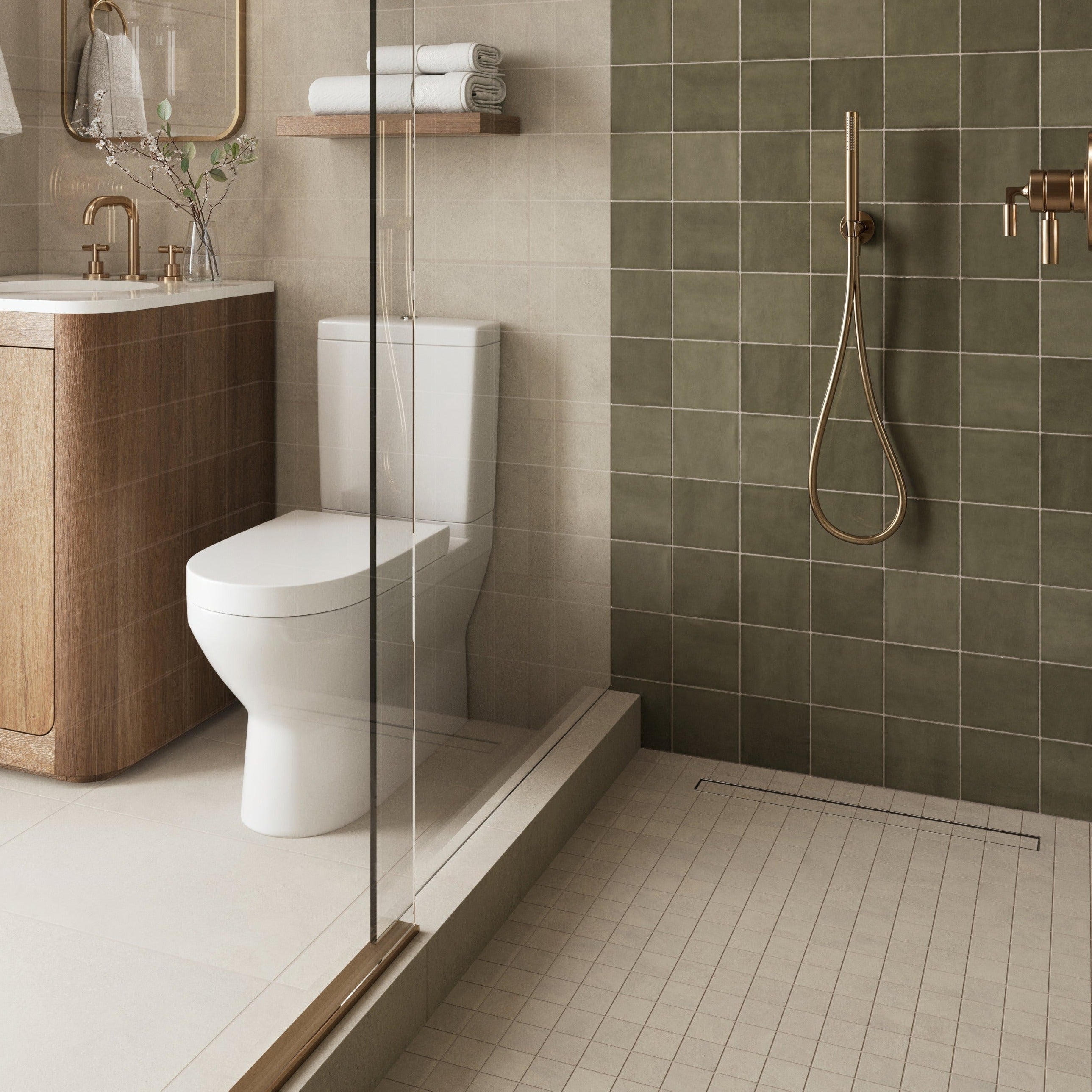 Modern bathroom with a wood vanity, glass-enclosed shower featuring green tiles, and gold fixtures for a warm, stylish design.