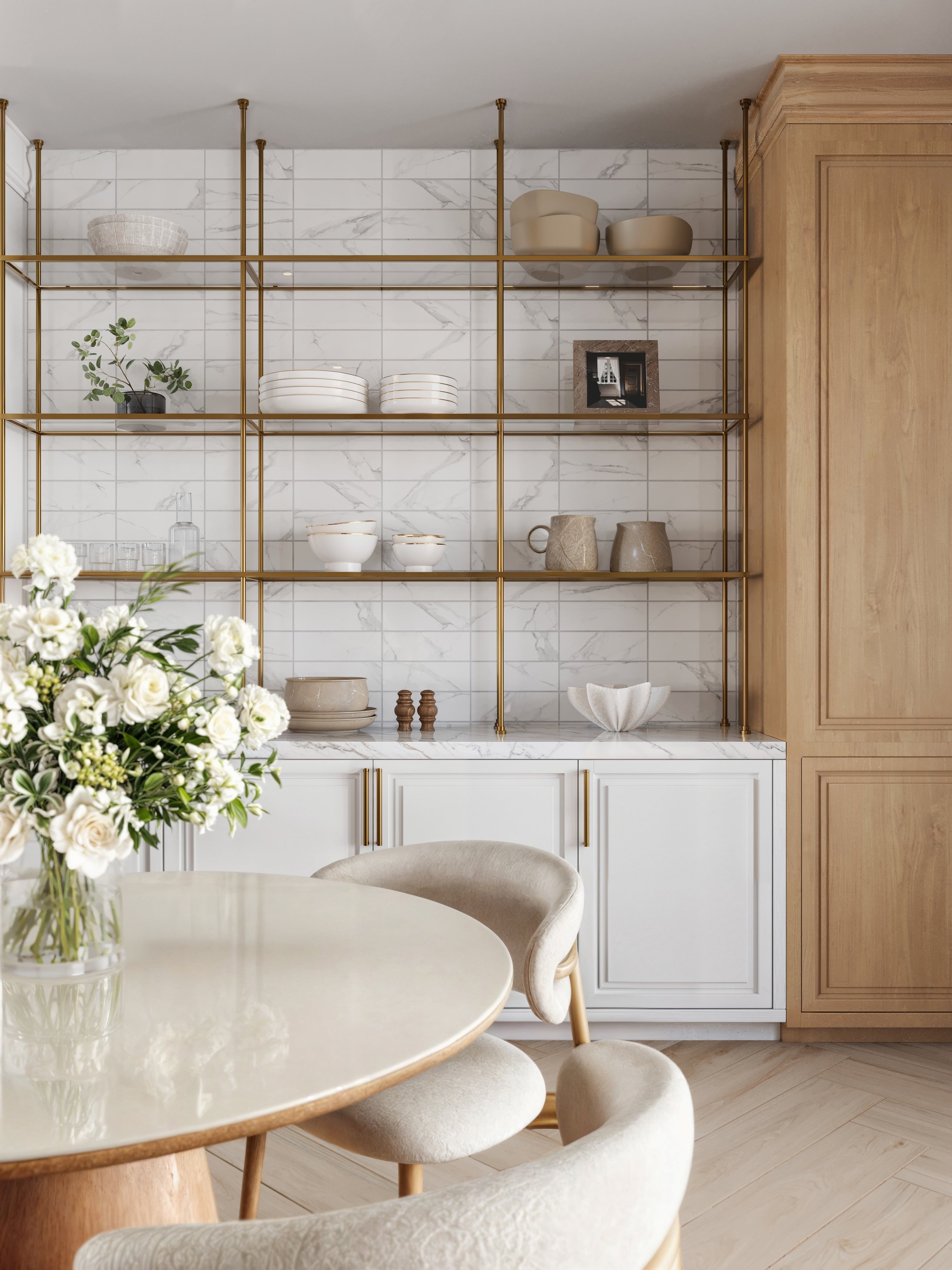 Elegant kitchen shelving adorned with brass accents, featuring a Julianna Carrara marble tile backsplash with subtle gray veining for timeless sophistication.