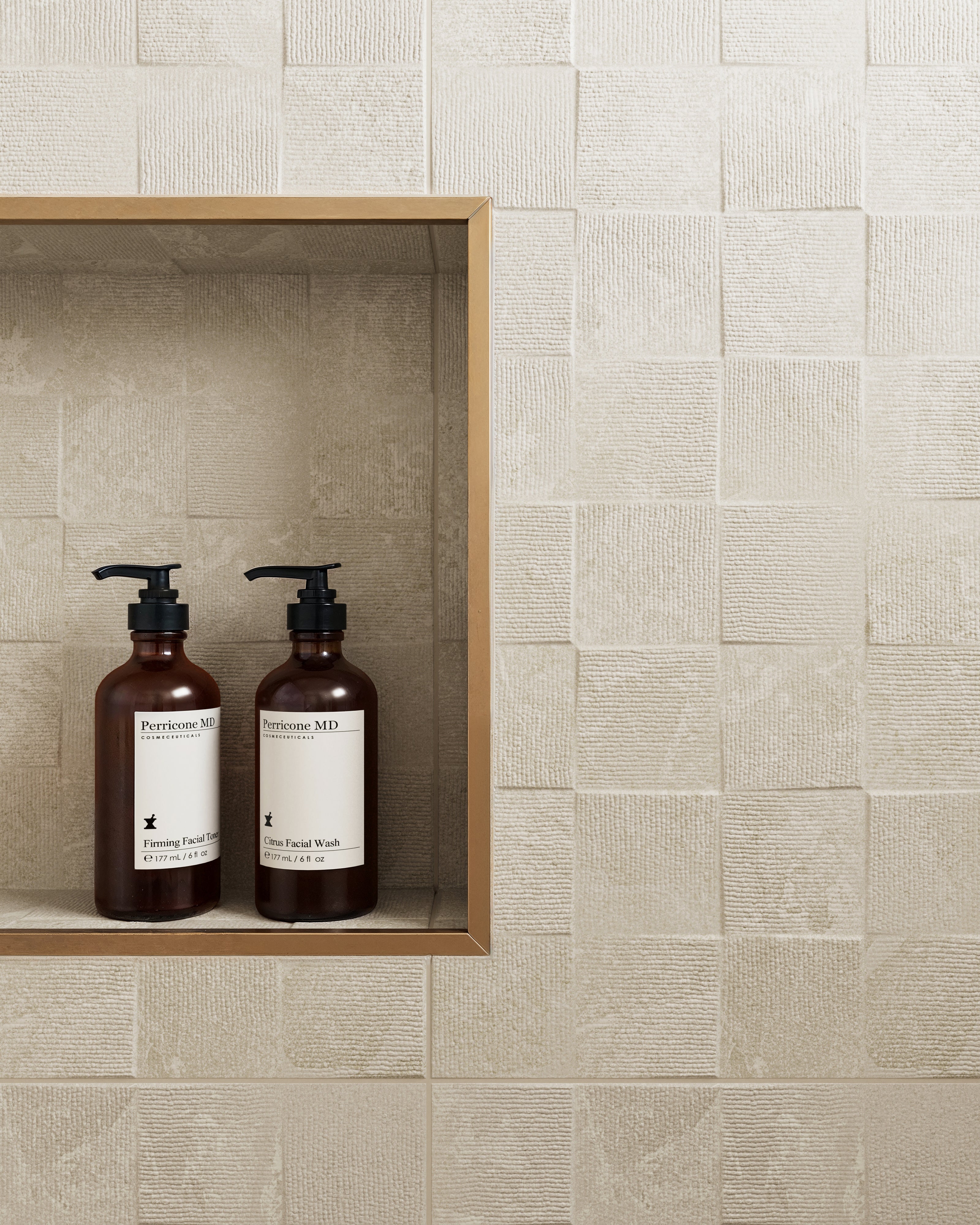 Close-up of Annalise Sand 12x36 Deco Matte Tile with a beige textured geometric design, featuring a built-in shelf with soap bottles for a functional and elegant look.