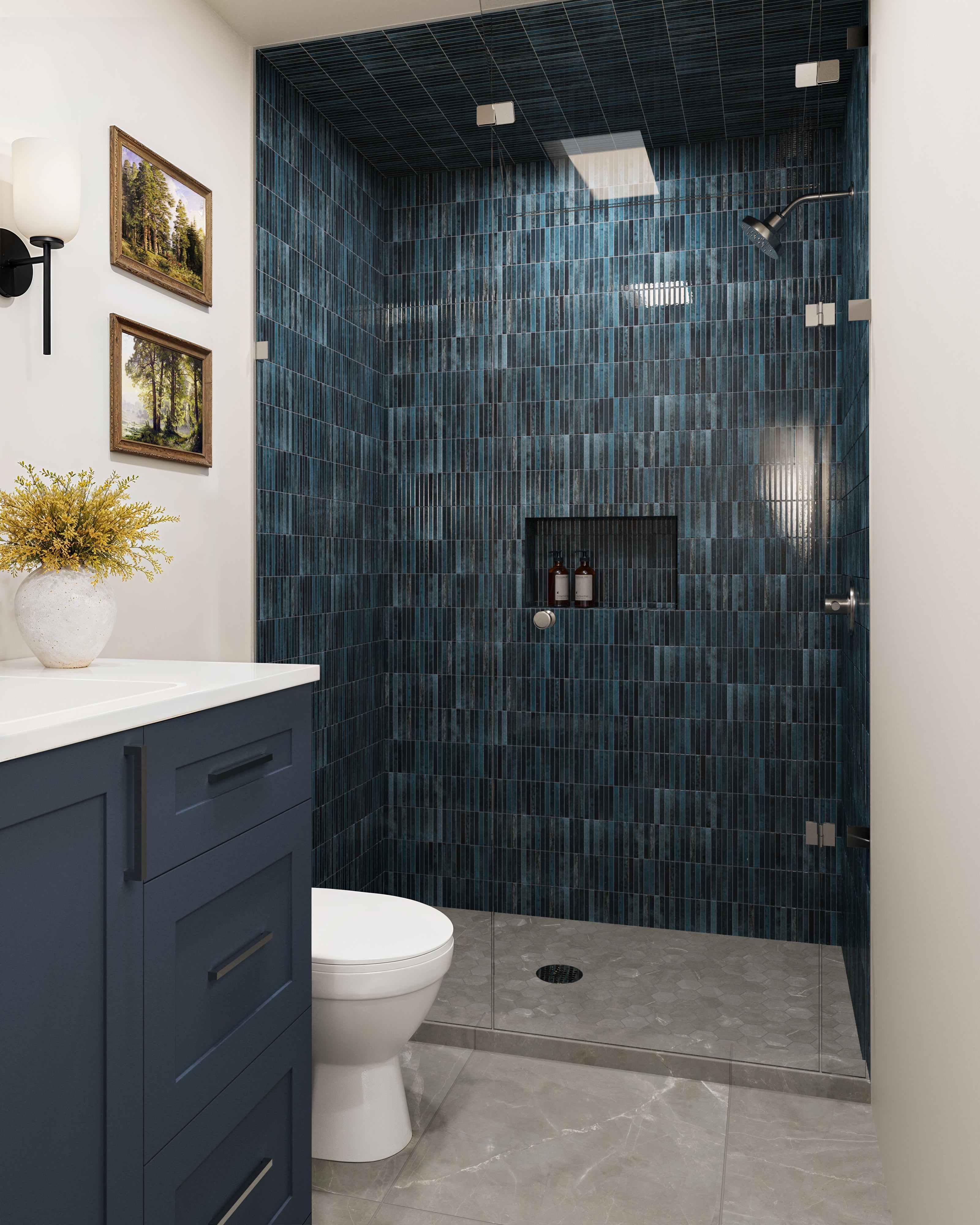 A bathroom with Leona Amani Grey 3x3 hexagon mosaic matte tile on the shower floor, paired with Miley deep blue porcelain wall tiles and a navy vanity.