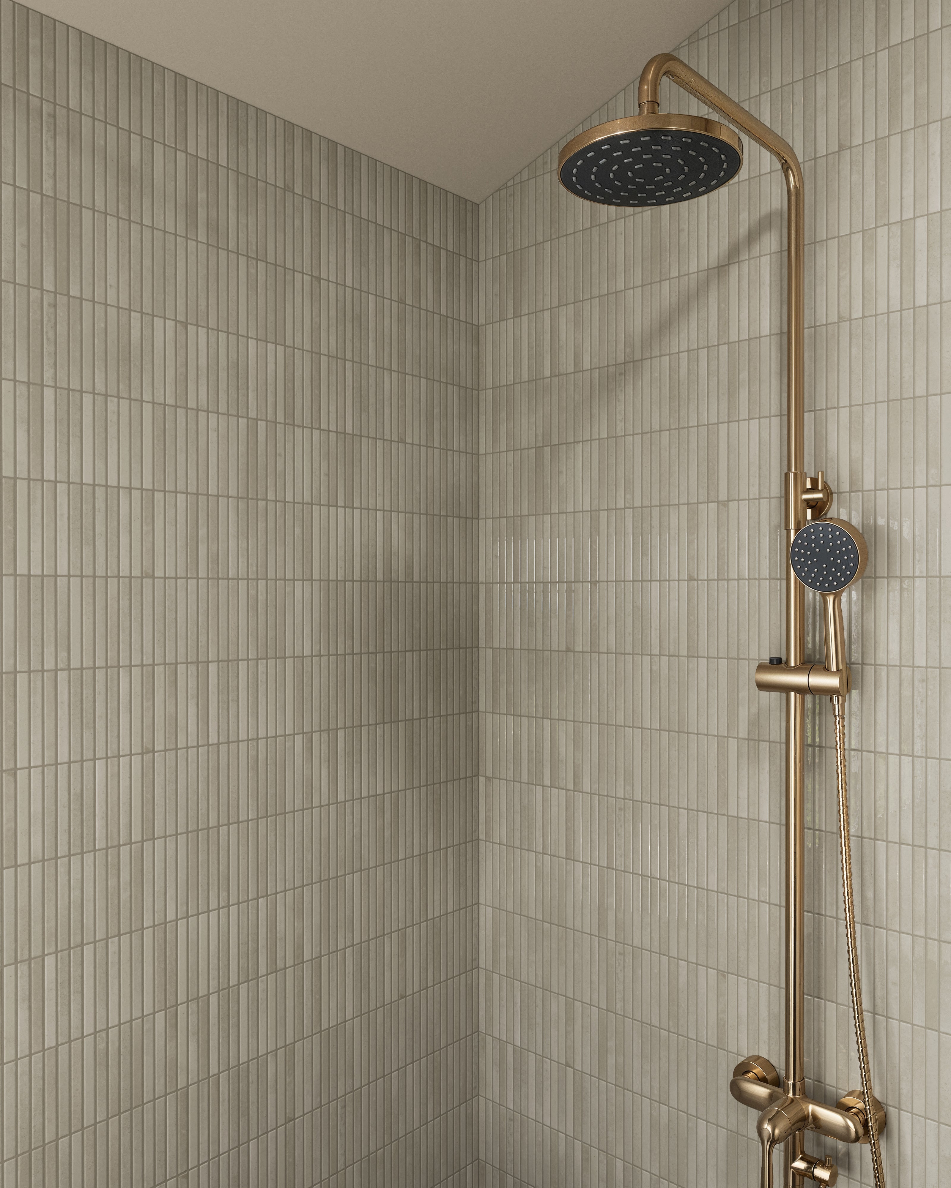 Vertical shower area featuring Miley tiles with a sleek, ribbed texture in soft beige-taupe hues, perfectly complemented by a luxurious brass shower fixture