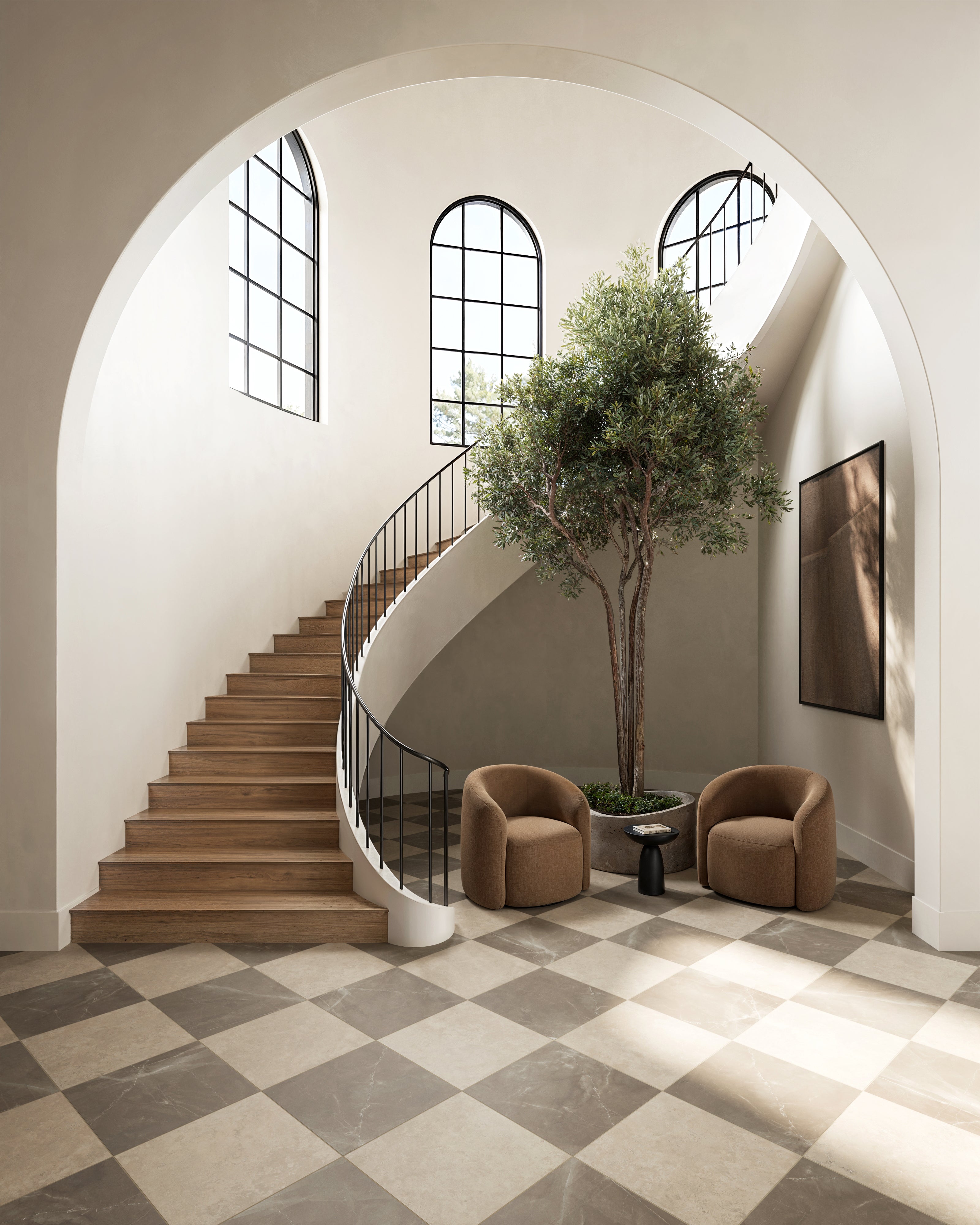 Leona 24x24 matte porcelain tile in marfil beige and Amani brown, grounding a grand entryway with classic checkerboard elegance.