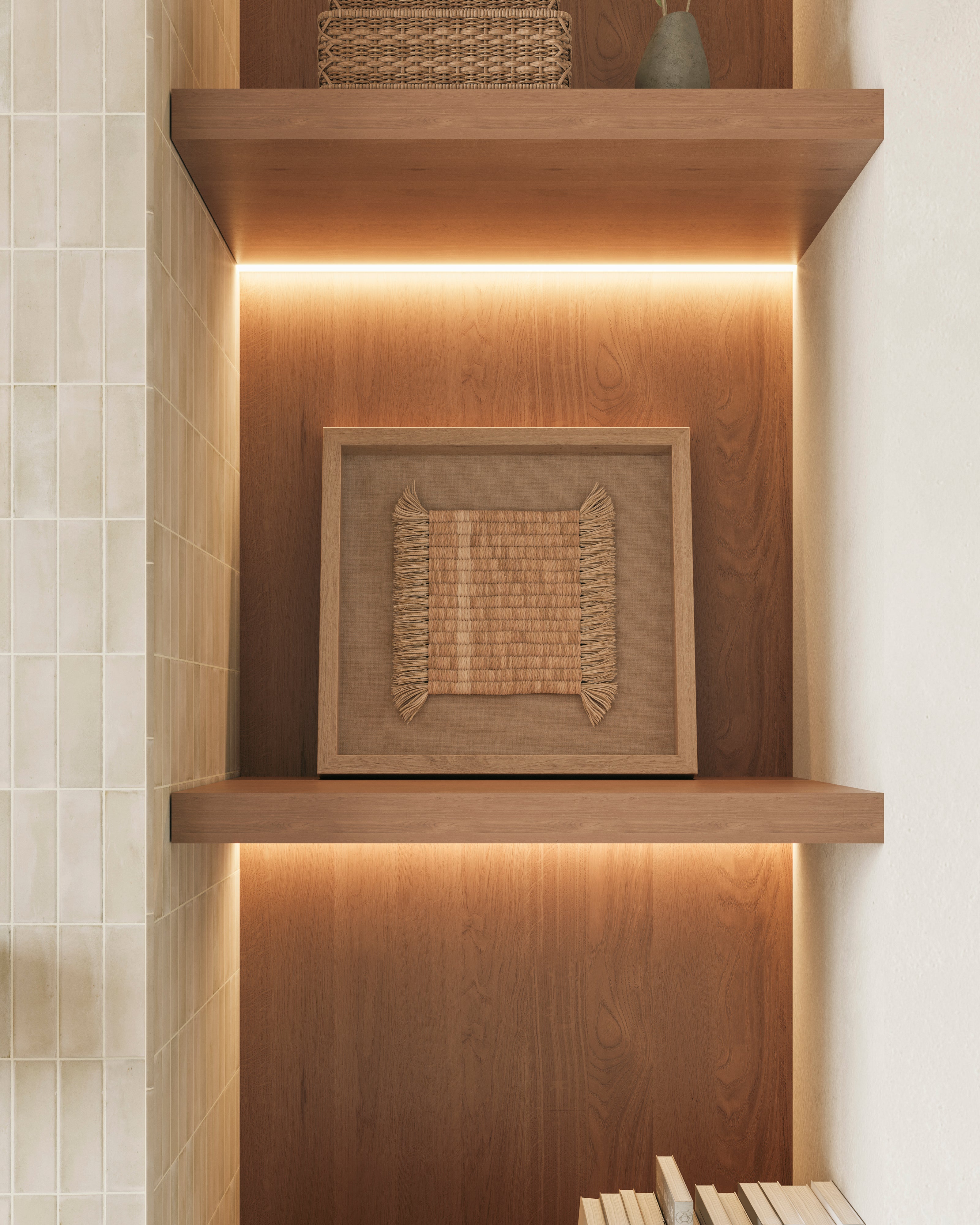 Built-in wood shelving with warm LED strip lighting highlights framed woven textile wall art, set against a smooth wood back panel.