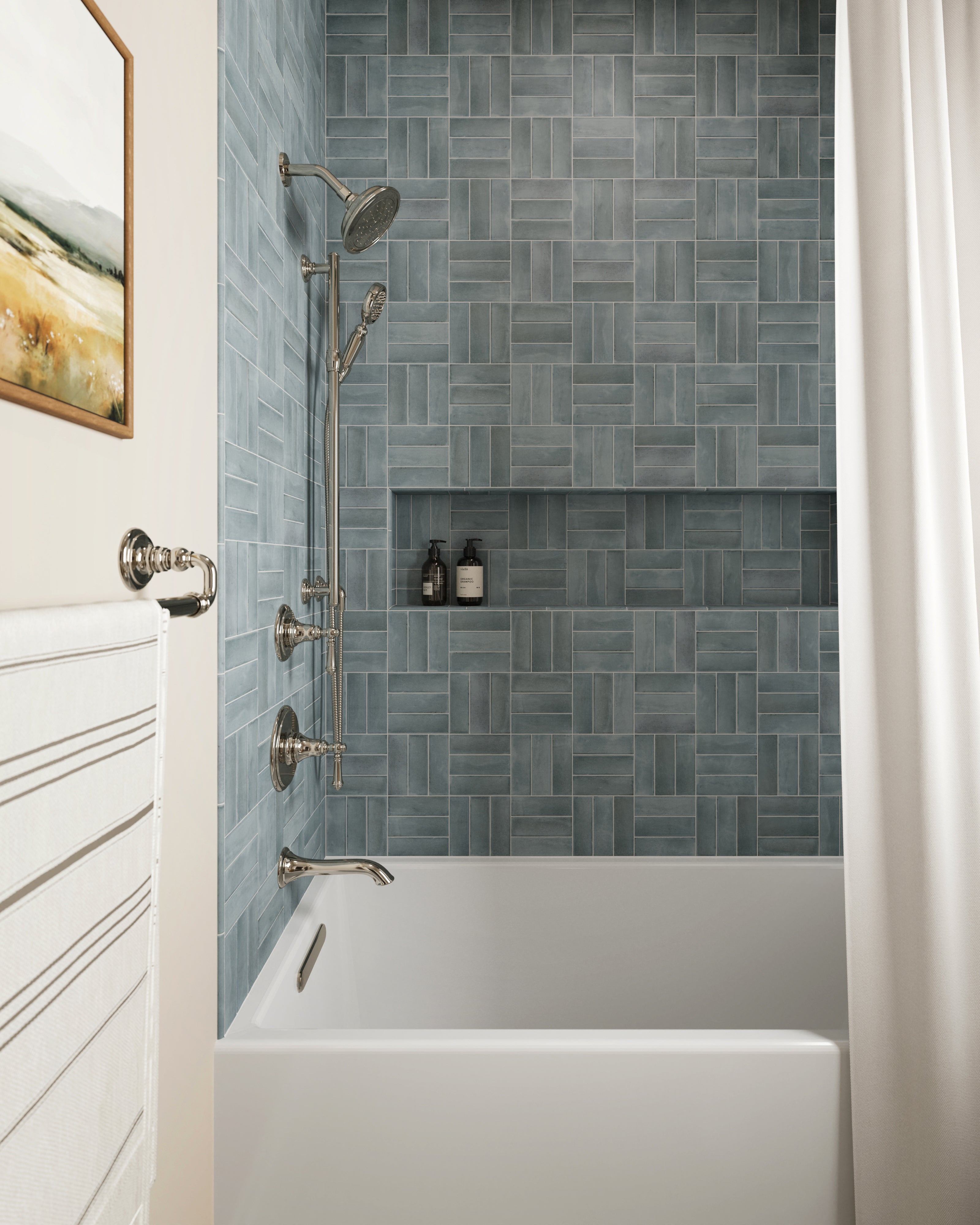 Natasha 0.5x8 matte ceramic tile trim in Ice, framing soft blue shower tiles with a clean, minimalist finish in a serene bath setting.