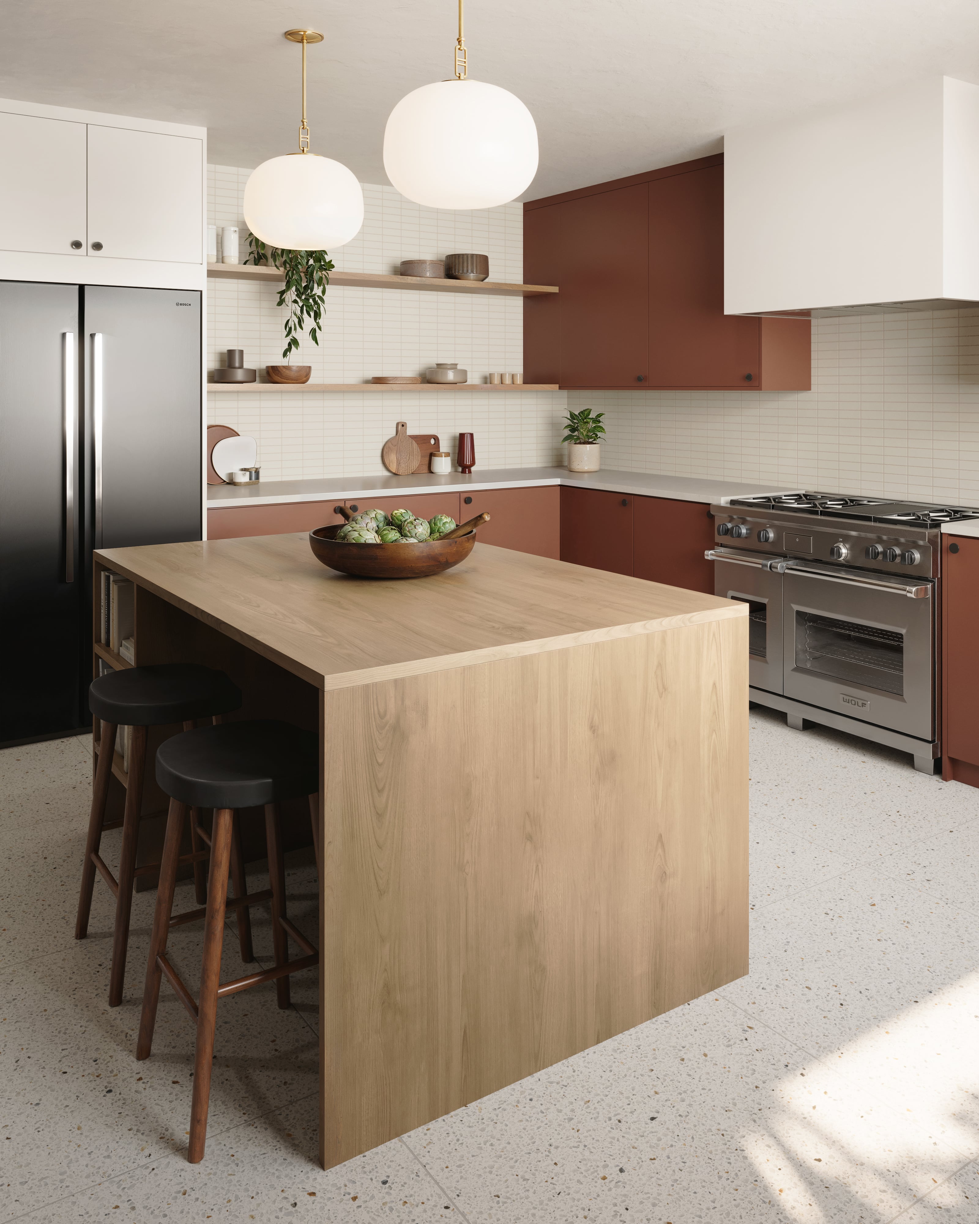 Installed above the island, our Kaley 16” Pendants in Aged Brass bring ambient glow and organic softness to a kitchen defined by warm tones and clean lines.