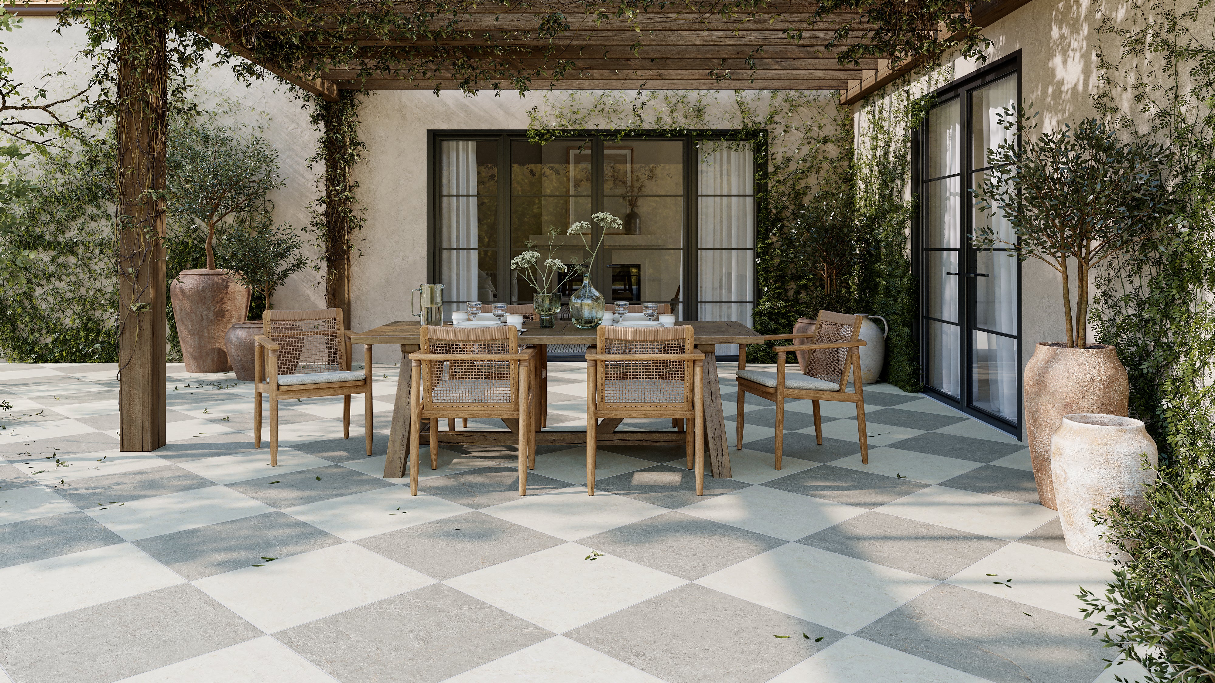 Outdoor dining patio with pergola featuring 24x24 checkerboard grip porcelain paver tile in 2cm thick light gray and off-white tones