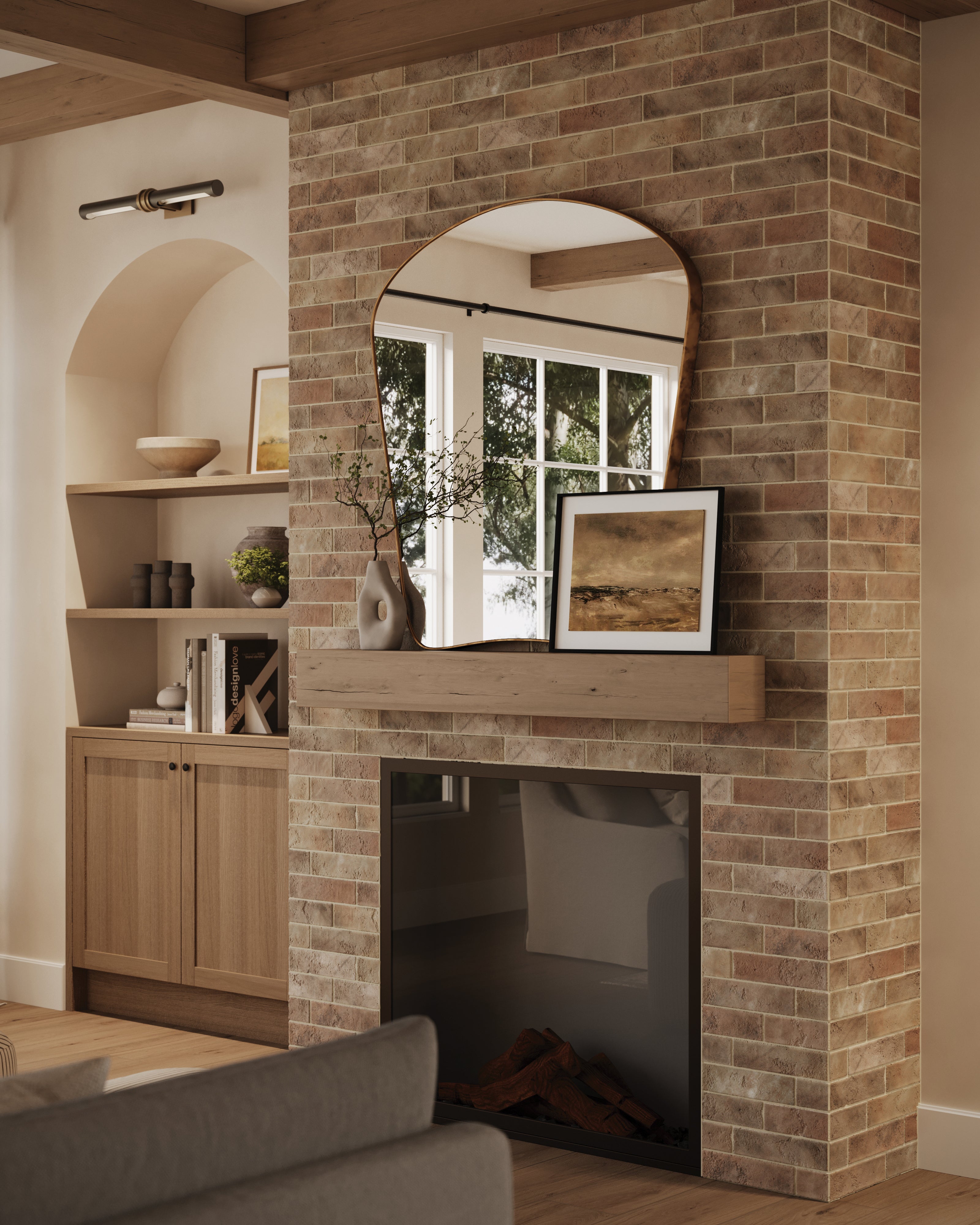 Rustic almond-colored brick wall tiles surround the fireplace, paired with a wooden mantel, organic-shaped mirror, and minimal decor accents for a natural, cozy aesthetic.