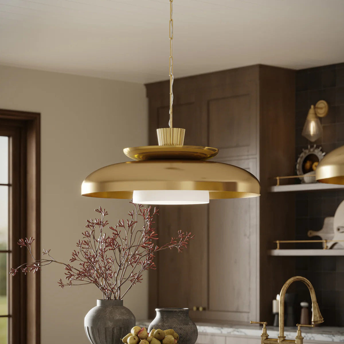 Gold pendant light fixture in a kitchen setting with neutral tones