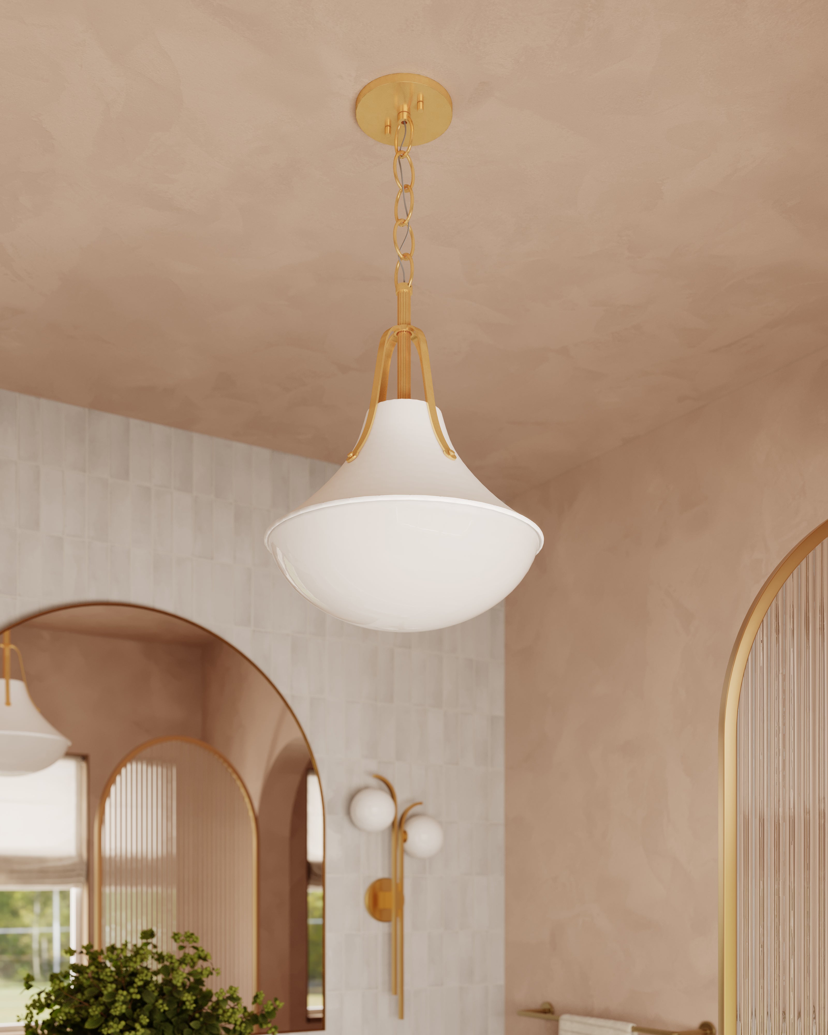Vintage gold leaf pendant light with a sculptural flared shade and smooth white diffuser, providing warm ambient illumination in a softly textured, arched-space interior.