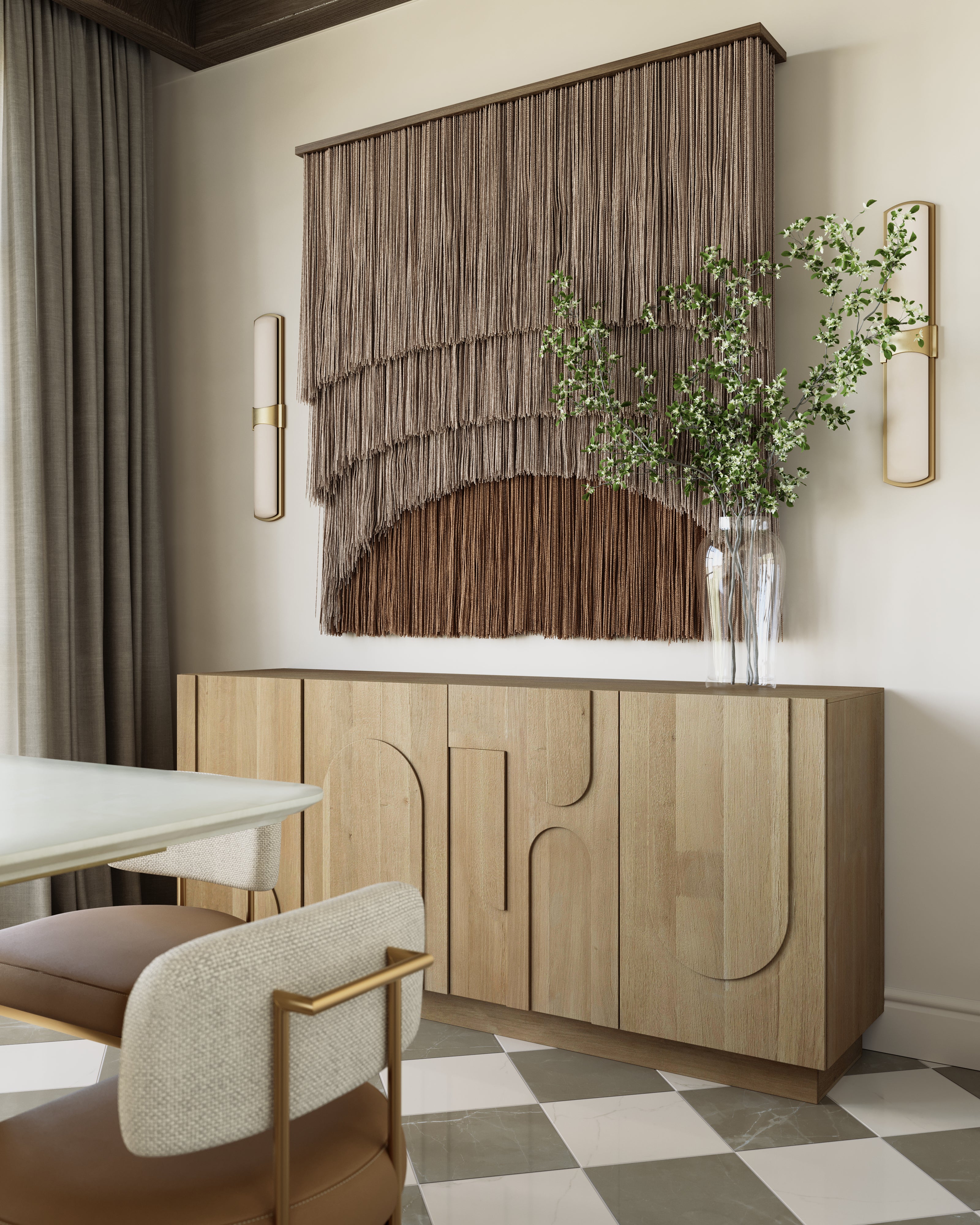 Light oak sideboard featuring sculptural door patterns, complementing the earth-toned decor, macrame wall art, and brass accents in a modern dining room.