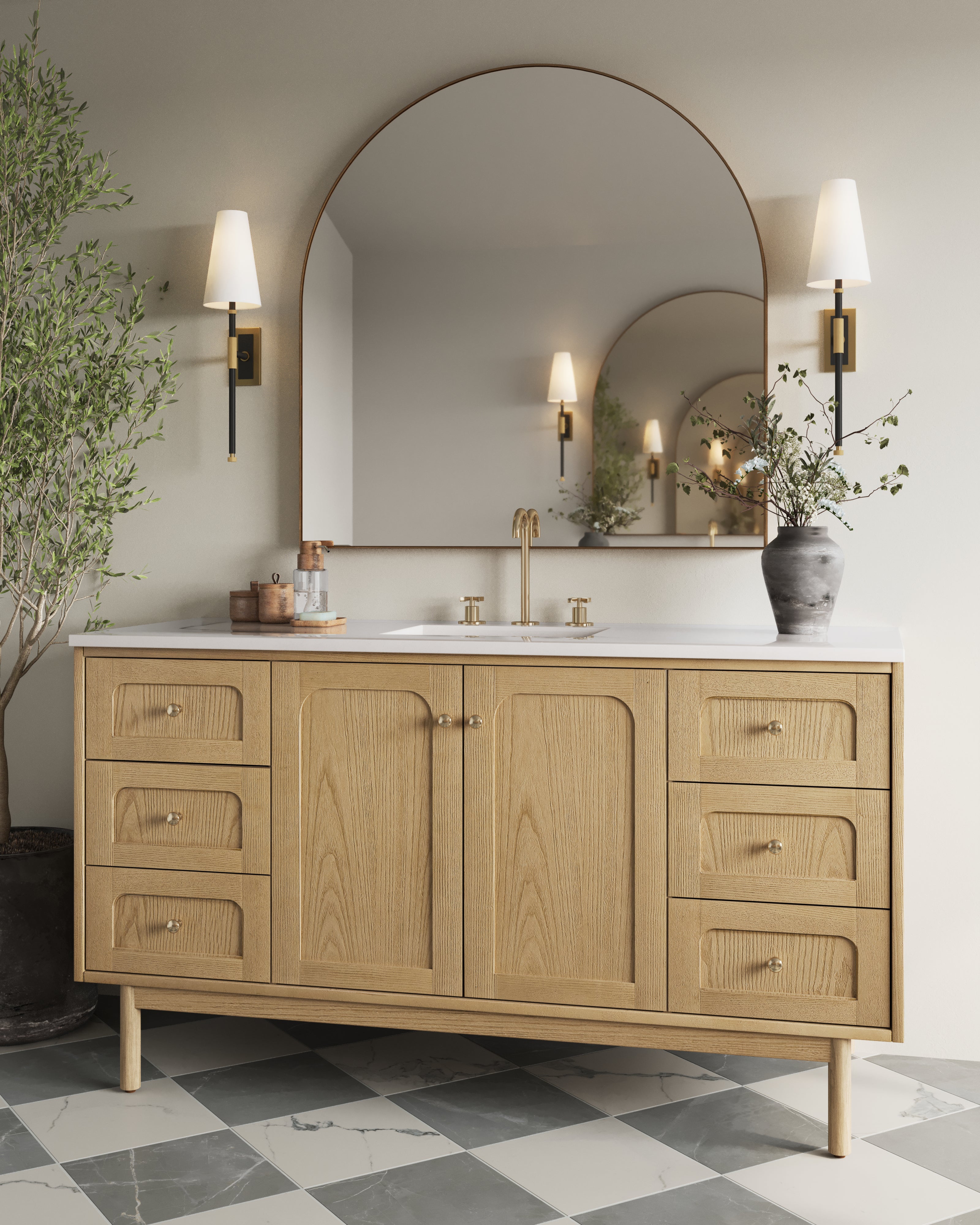 Abigail 60" single vanity in light natural oak with large arched mirror, paired with a brass faucet and marble checkerboard tile floor.