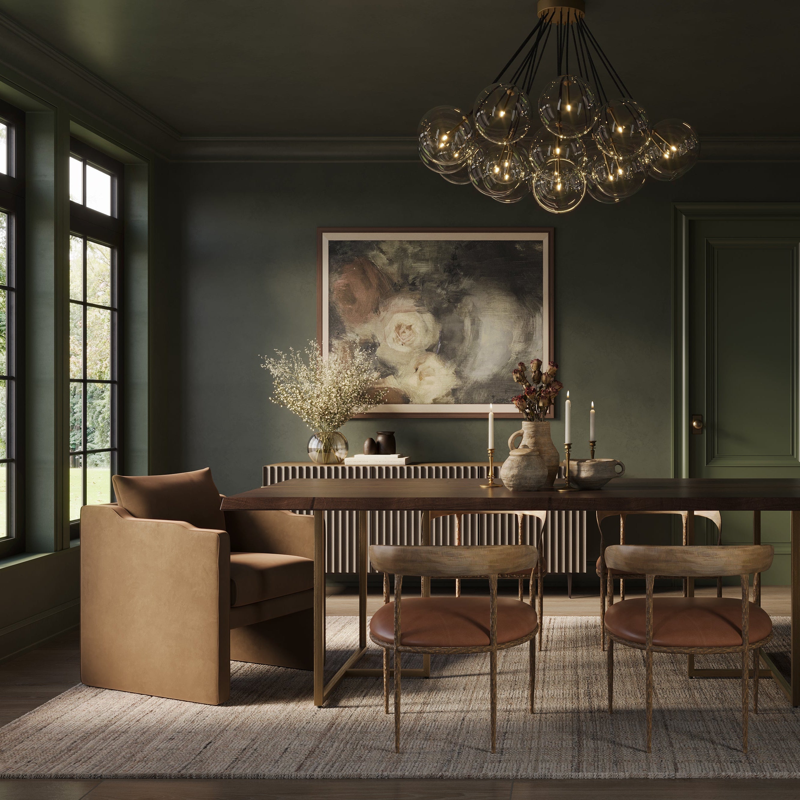 Elegant dining room with deep green walls, a glass globe chandelier, warm wood table, soft upholstered chairs, and large floral artwork