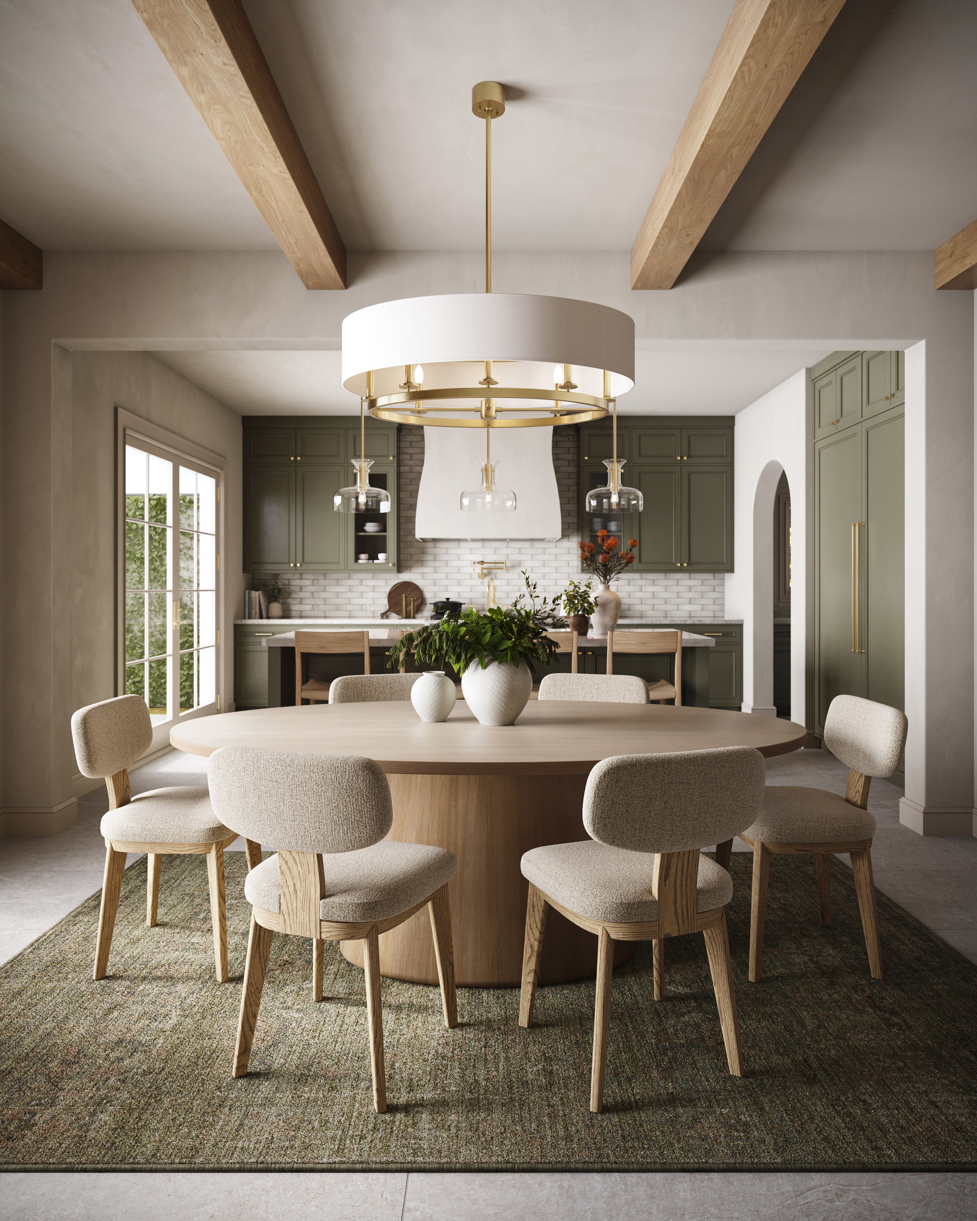 Spacious dining room featuring a round wood table, six upholstered chairs, brass chandelier, and soft green cabinetry with natural light.