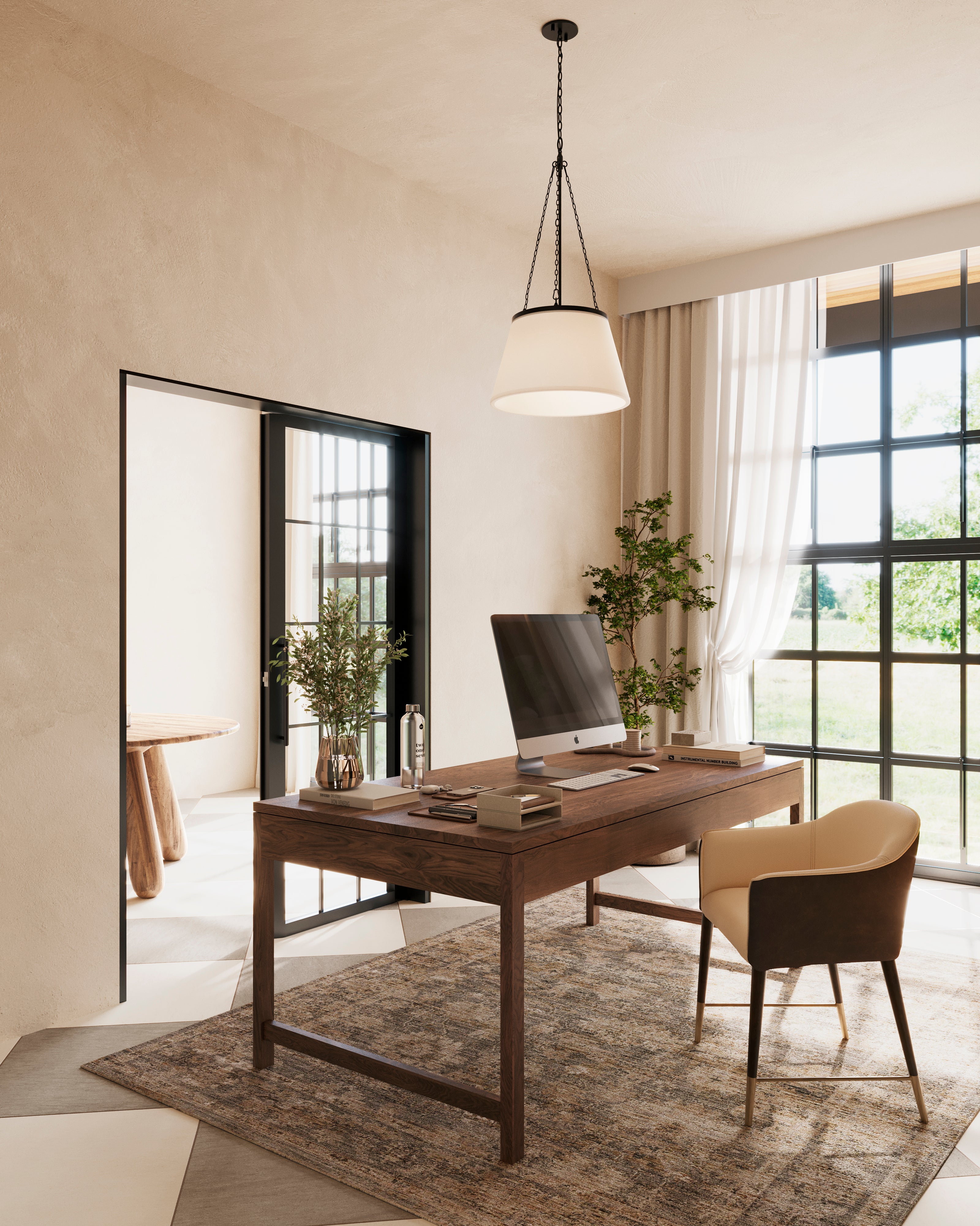 Matte black chain hung pendant light with a white fabric shade illuminating a home office with a wooden desk, large window, and neutral textured walls.