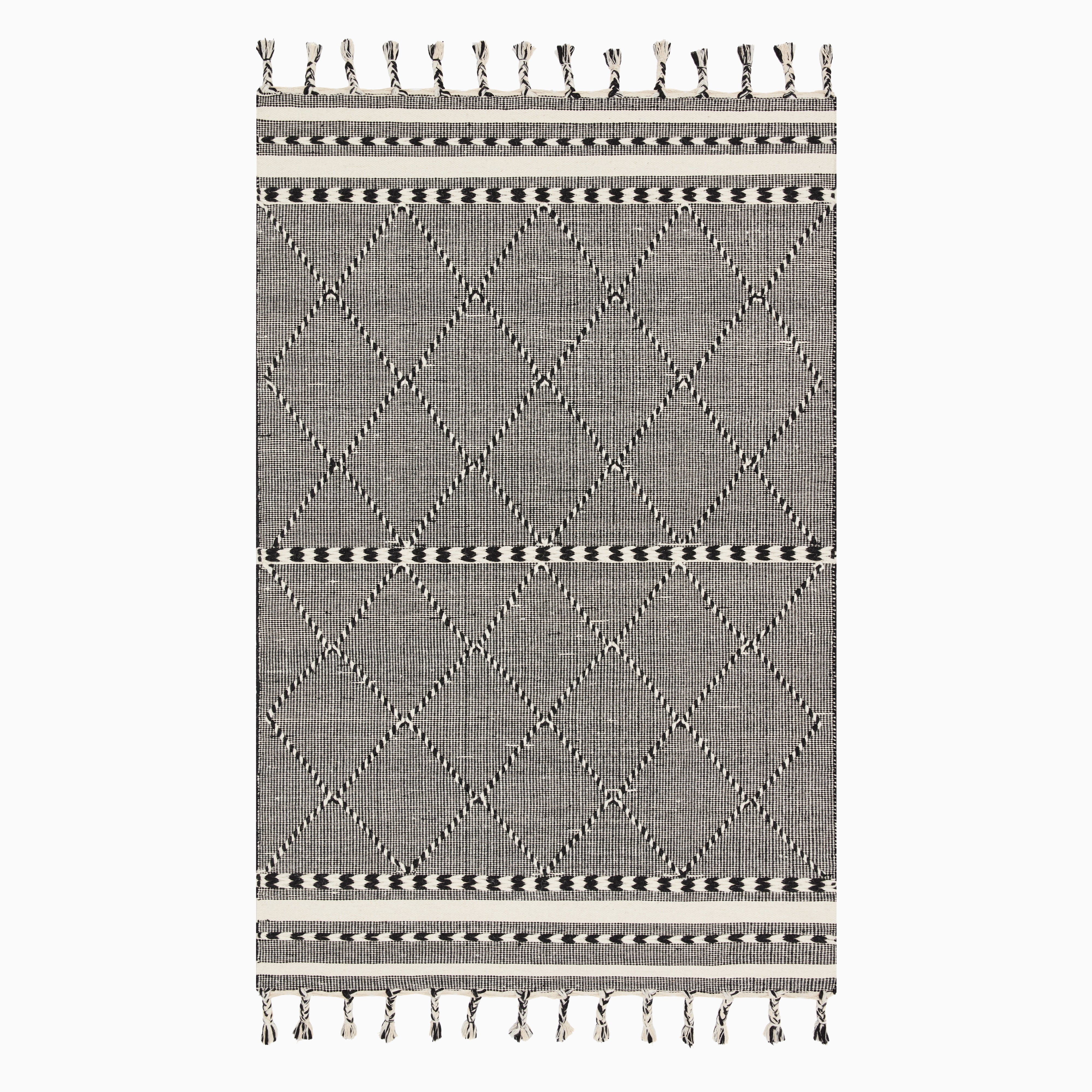 Hand loomed black and white wool rug with a geometric diamond pattern and decorative fringed edges.